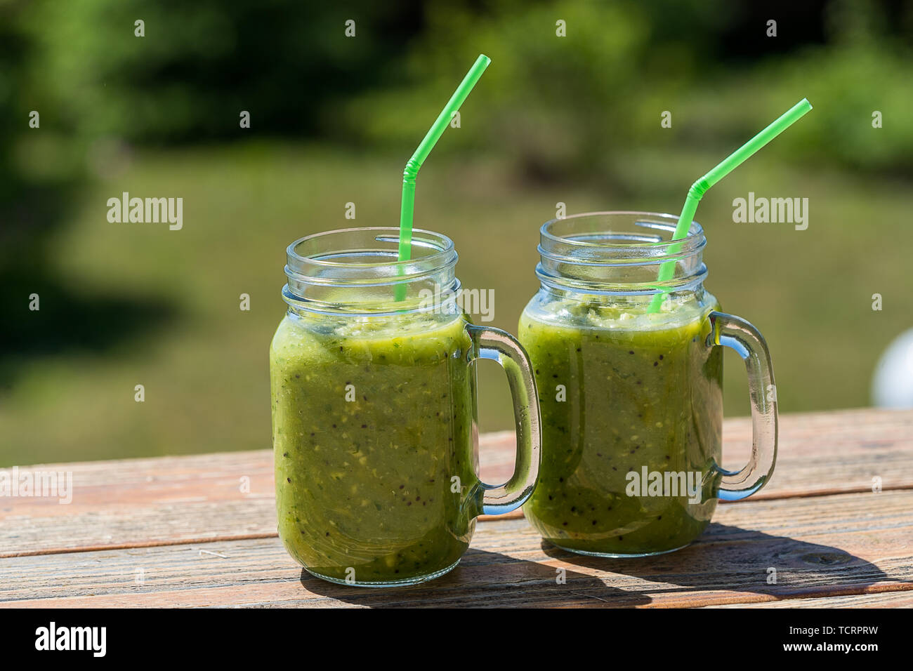 Healthy Vegan Green Smoothie With Spinach, apple, celery, kiwi, Brussels sprout, avocado, in glass jars, outdoor, over nature background Stock Photo - Alamy Healthy Vegan Green Smoothie With Spinach, apple, celery, kiwi, Brussels sprout, avocado, in glass jars, outdoor, over nature background Stock Photo - Alamy
