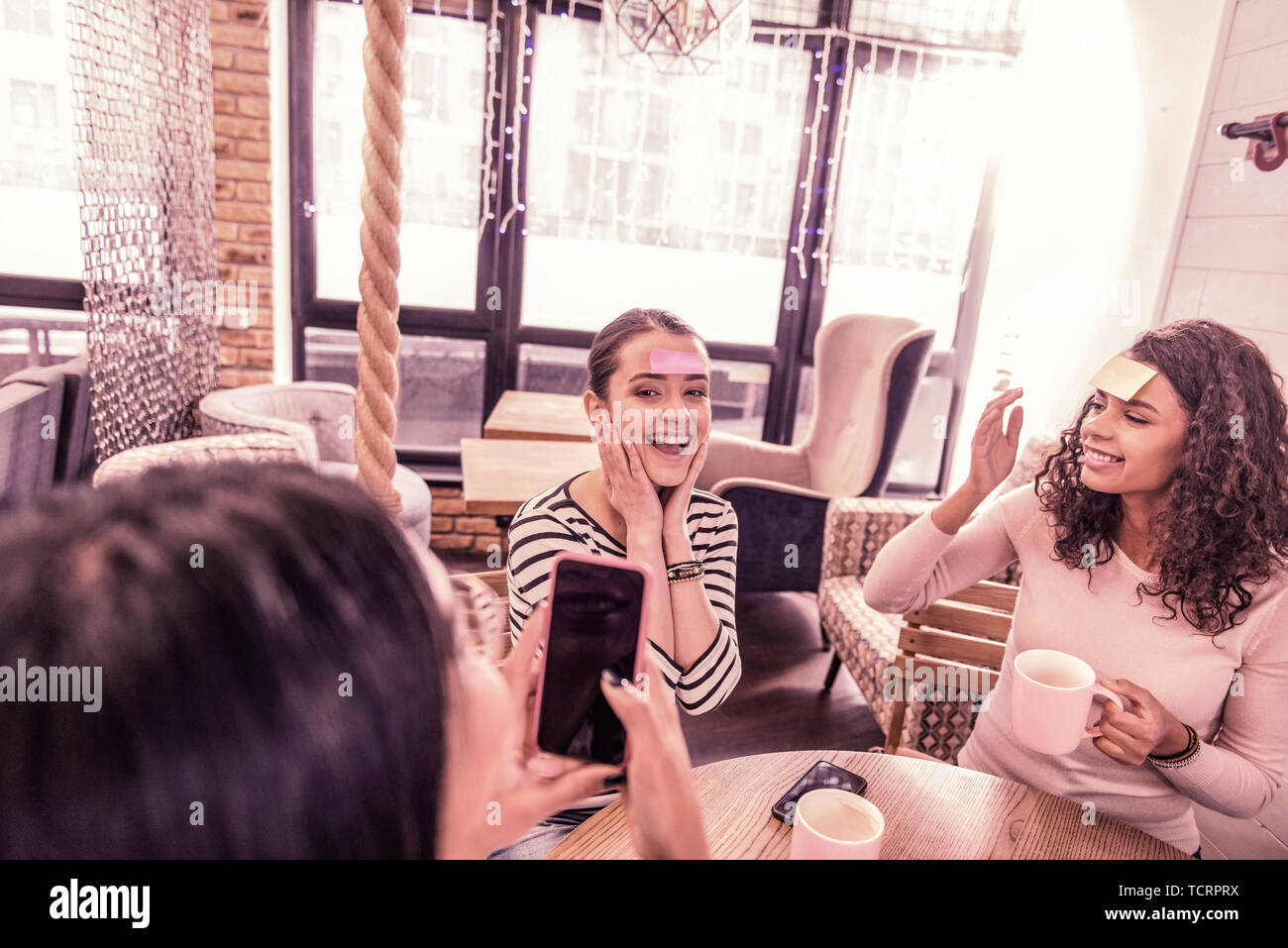Top view of three funny women using creative approach in studying foreign words Stock Photo