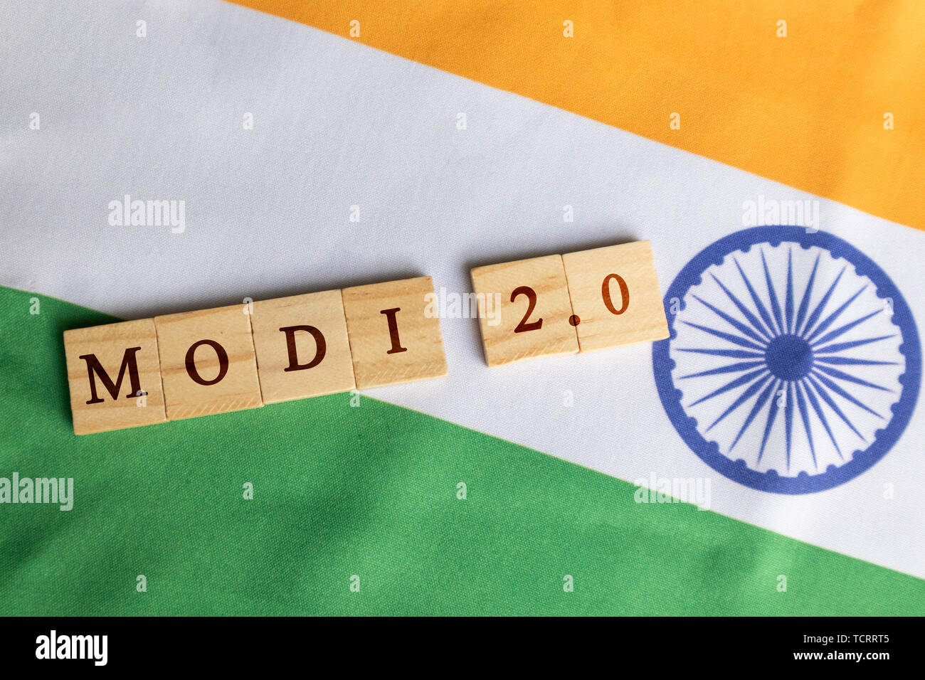 MAski, India - June, 09 2019 : Modi 2.0 wooden block letters on Indian Flag Stock Photo