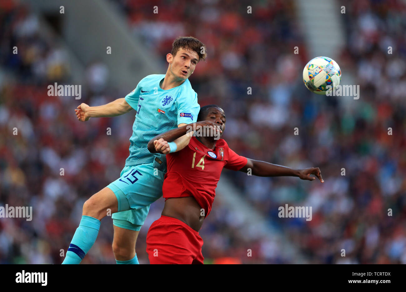 Netherlands' Marten de Roon (left) and Portugal's William Carvalho battle for the ball during the Nations League Final at Estadio do Dragao, Porto. Stock Photo