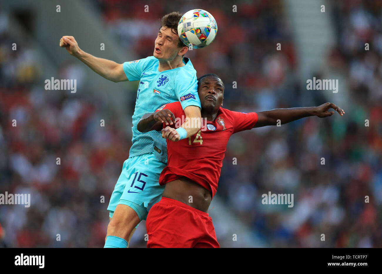 Netherlands' Marten de Roon (left) and Portugal's William Carvalho during the Nations League Final at Estadio do Dragao, Porto. Stock Photo