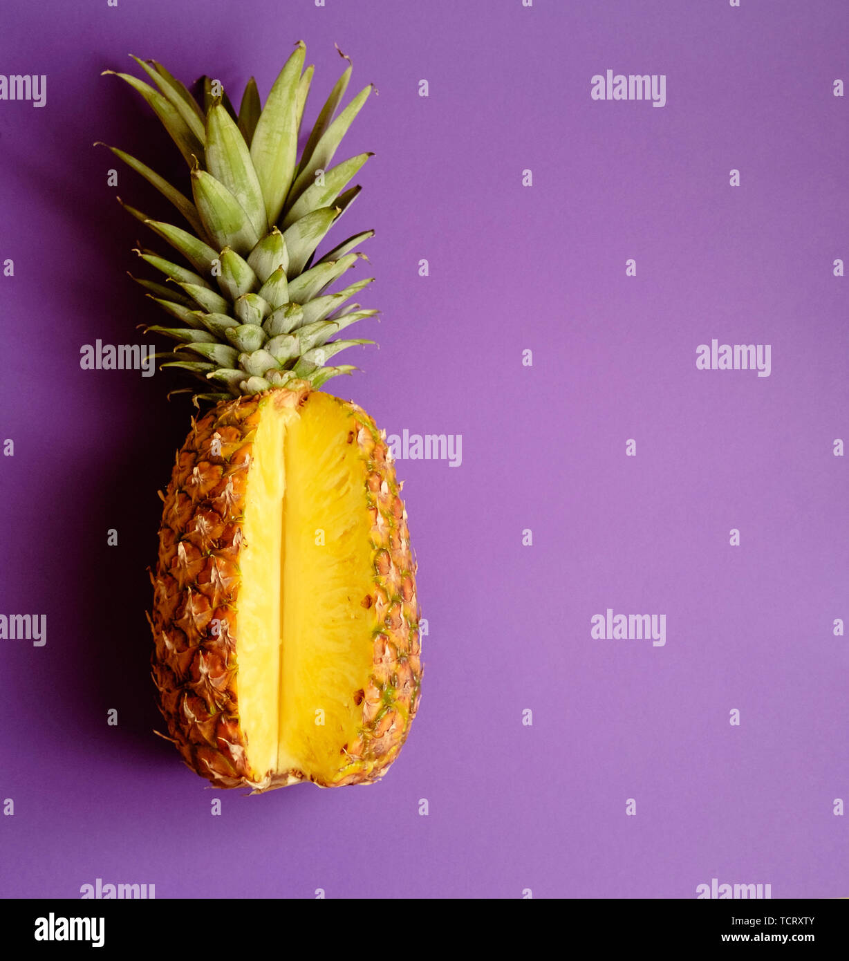 pineapple on deep purple pink background Stock Photo
