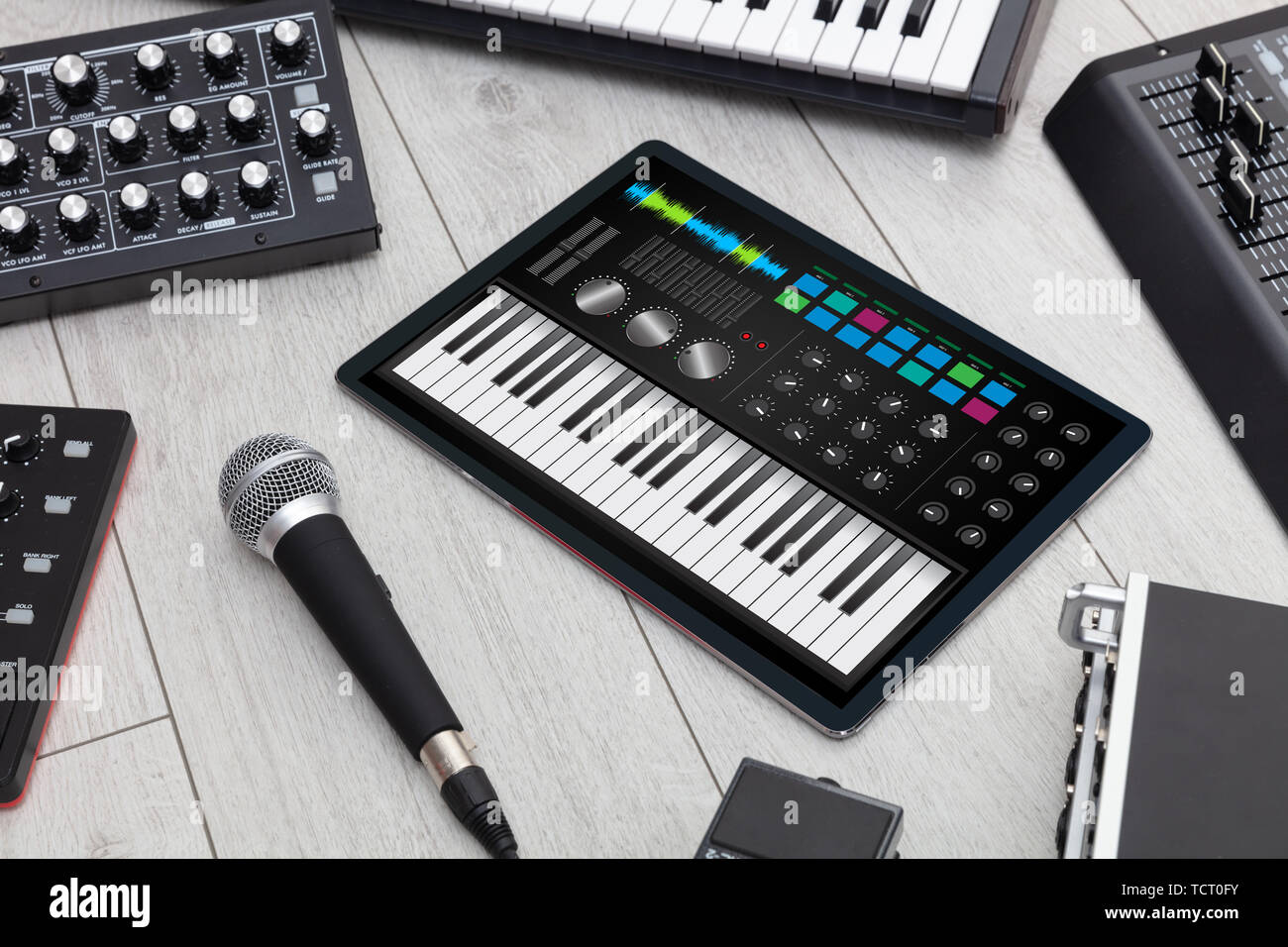 Piano synthesizer app on tablet and musical instrument concept Stock