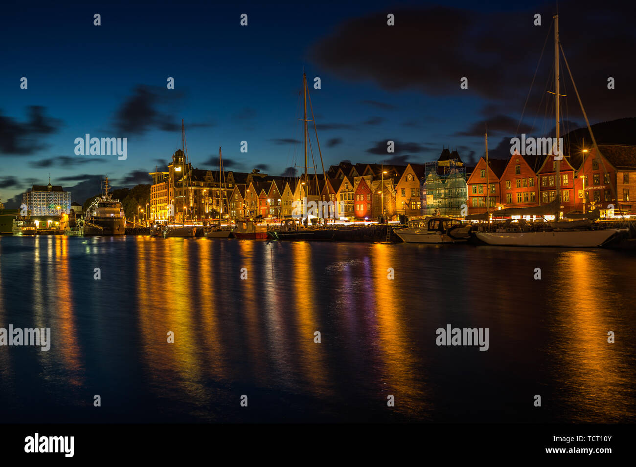 Scenic view at sunset of Bergen harbour and Bryggen waterfront, famous for its historic wooden houses part of UNESO World Heritage Site. Bergen, Norwa Stock Photo