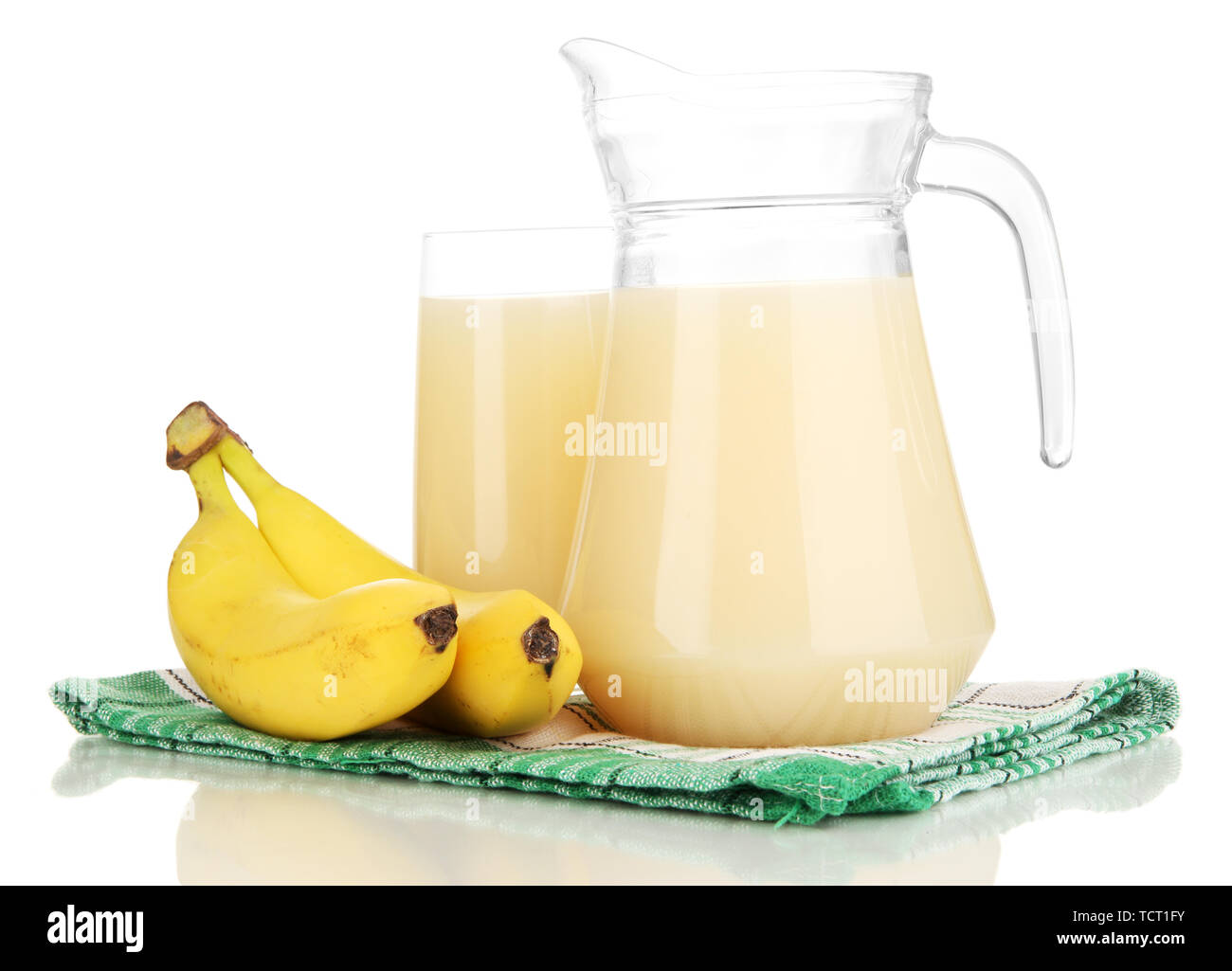 Full glass and jug of banana juice and bananas isolated on white Stock