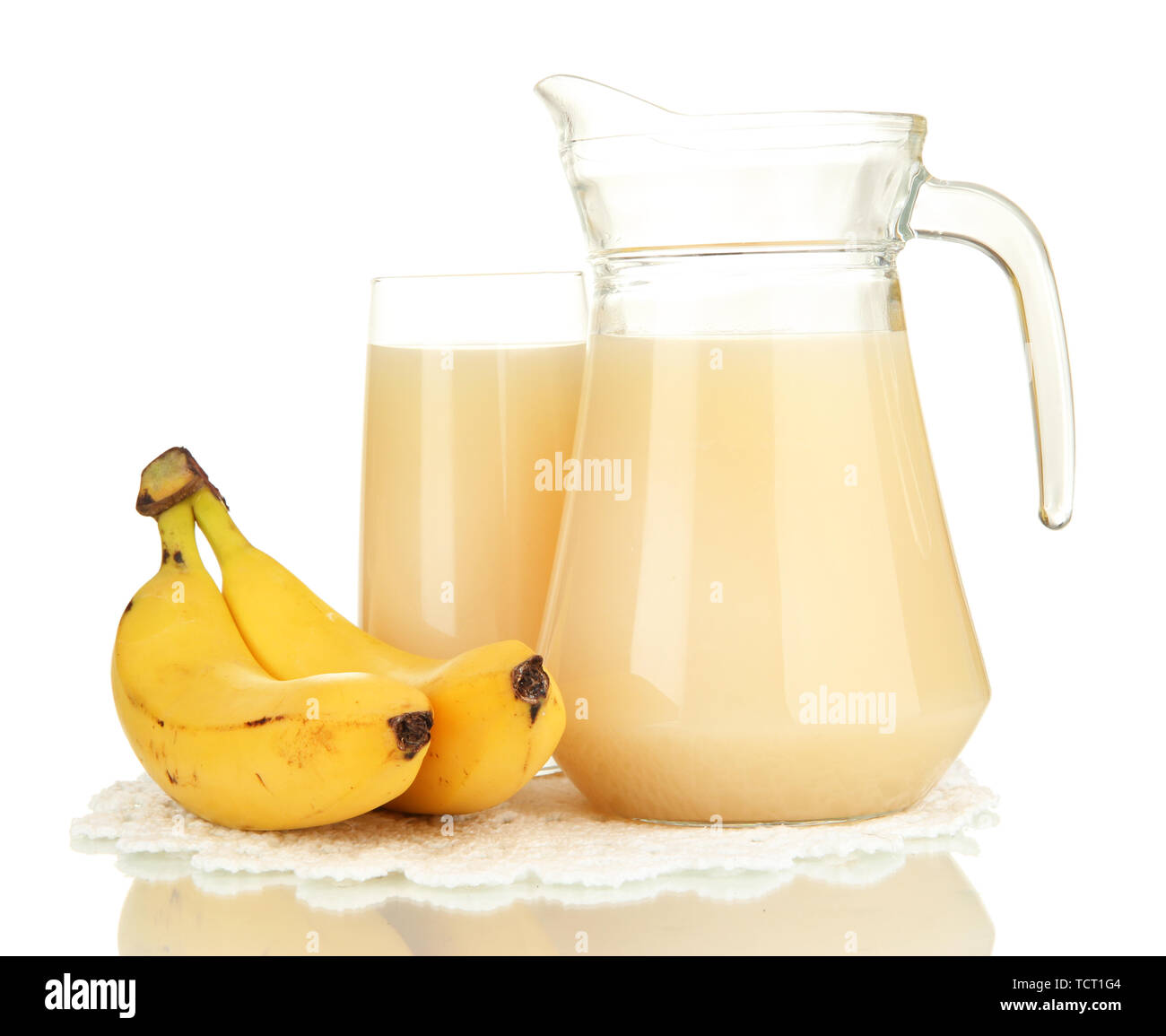 Full glass and jug of banana juice and bananas isolated on white Stock