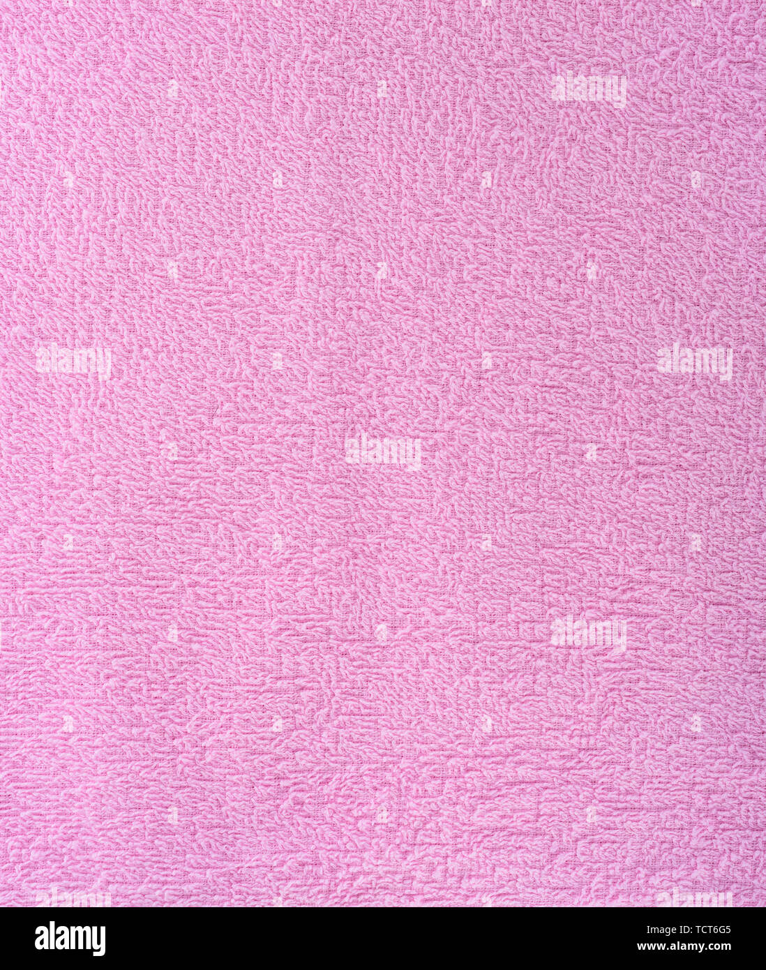 The texture of the fabric is pink terry towel. Terry cloth as a background. Close up Stock Photo