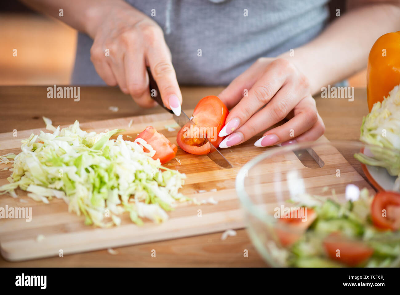 Woman cutting vegetables in the kitchen. Cooking healthy diet food concept  Stock Photo - Alamy