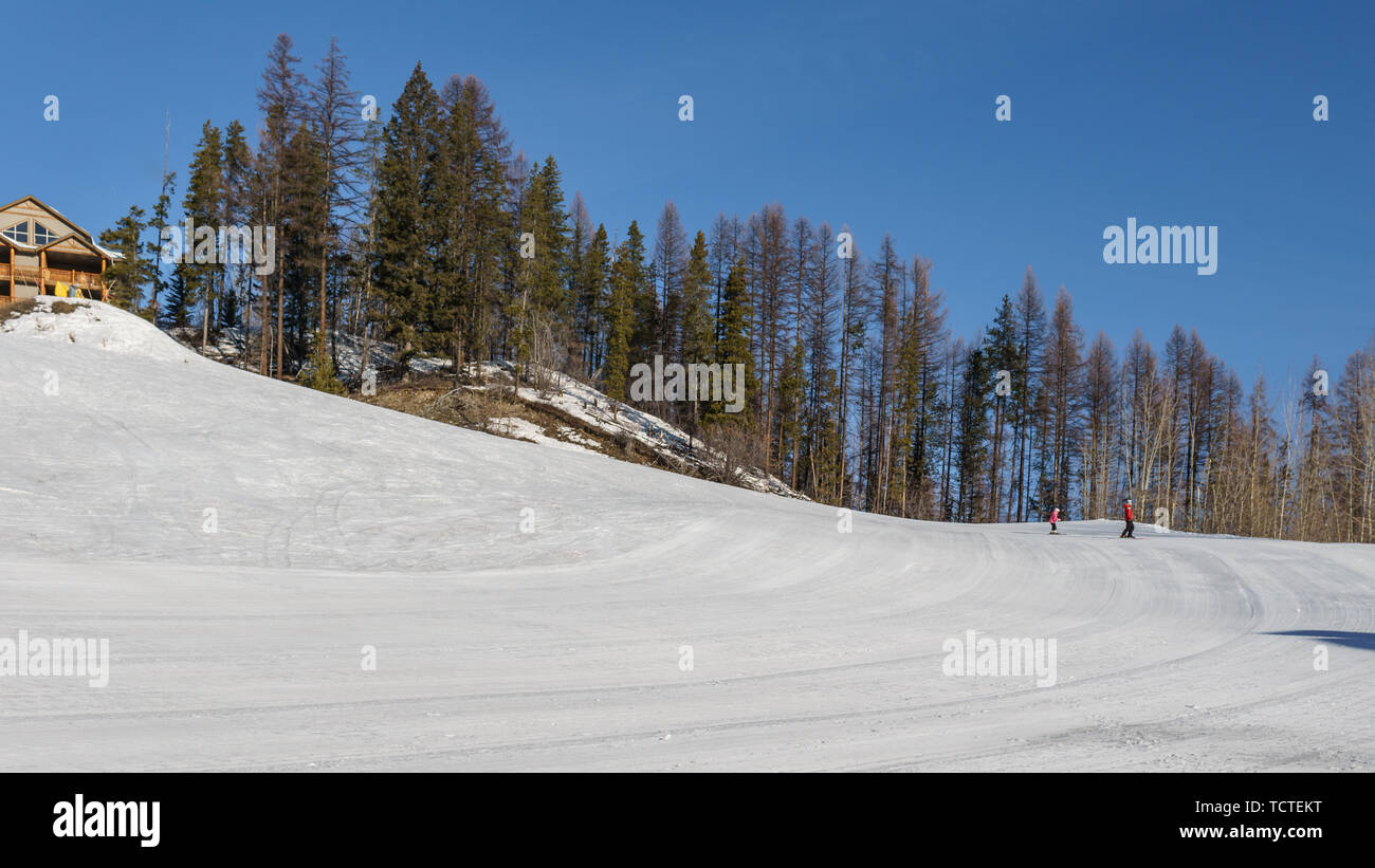 KIMBERLEY, CANADA - MARCH 22, 2019: Mountain Resort view early spring people skiing. Stock Photo