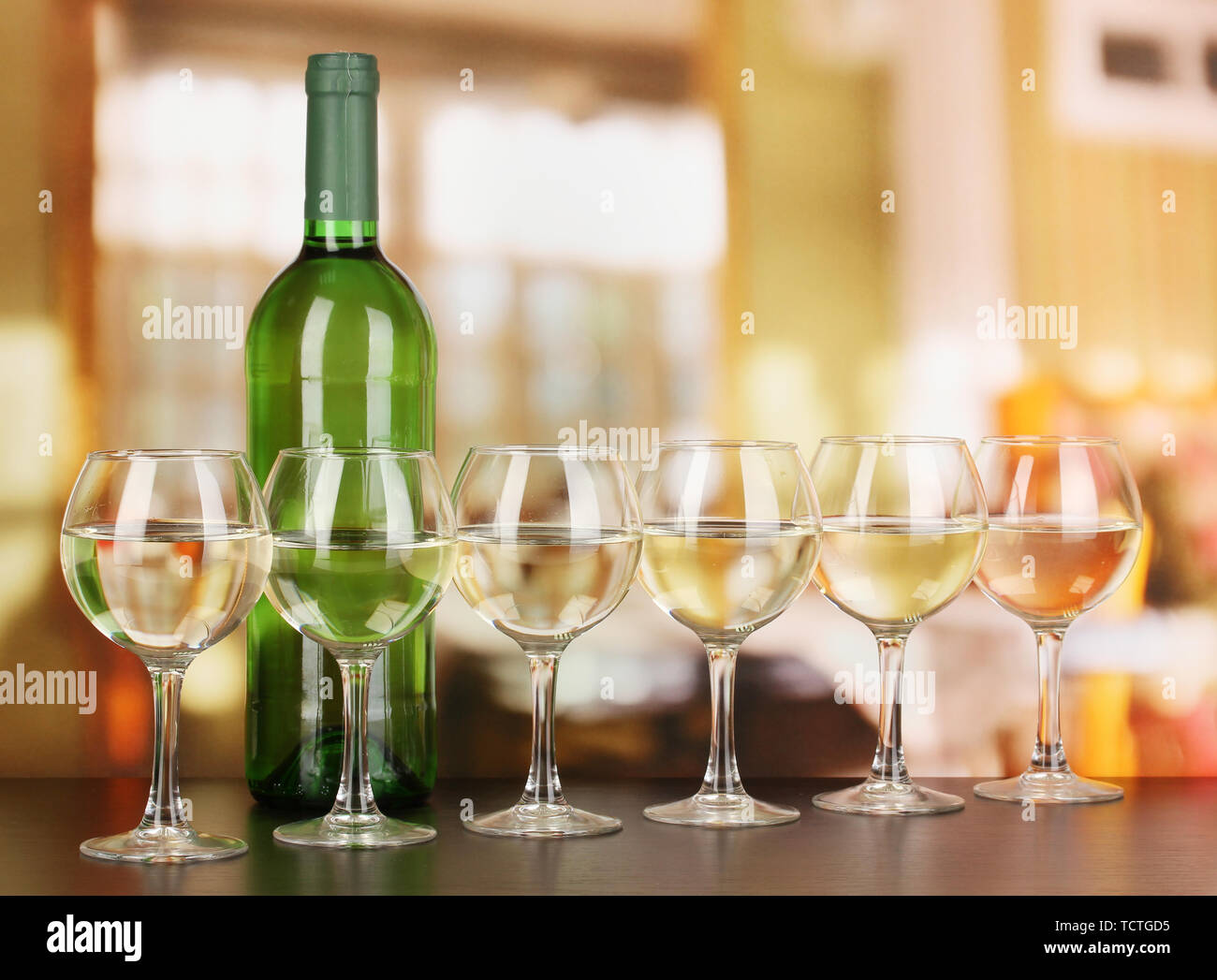 White wine in glass and bottle on room background Stock Photo Alamy
