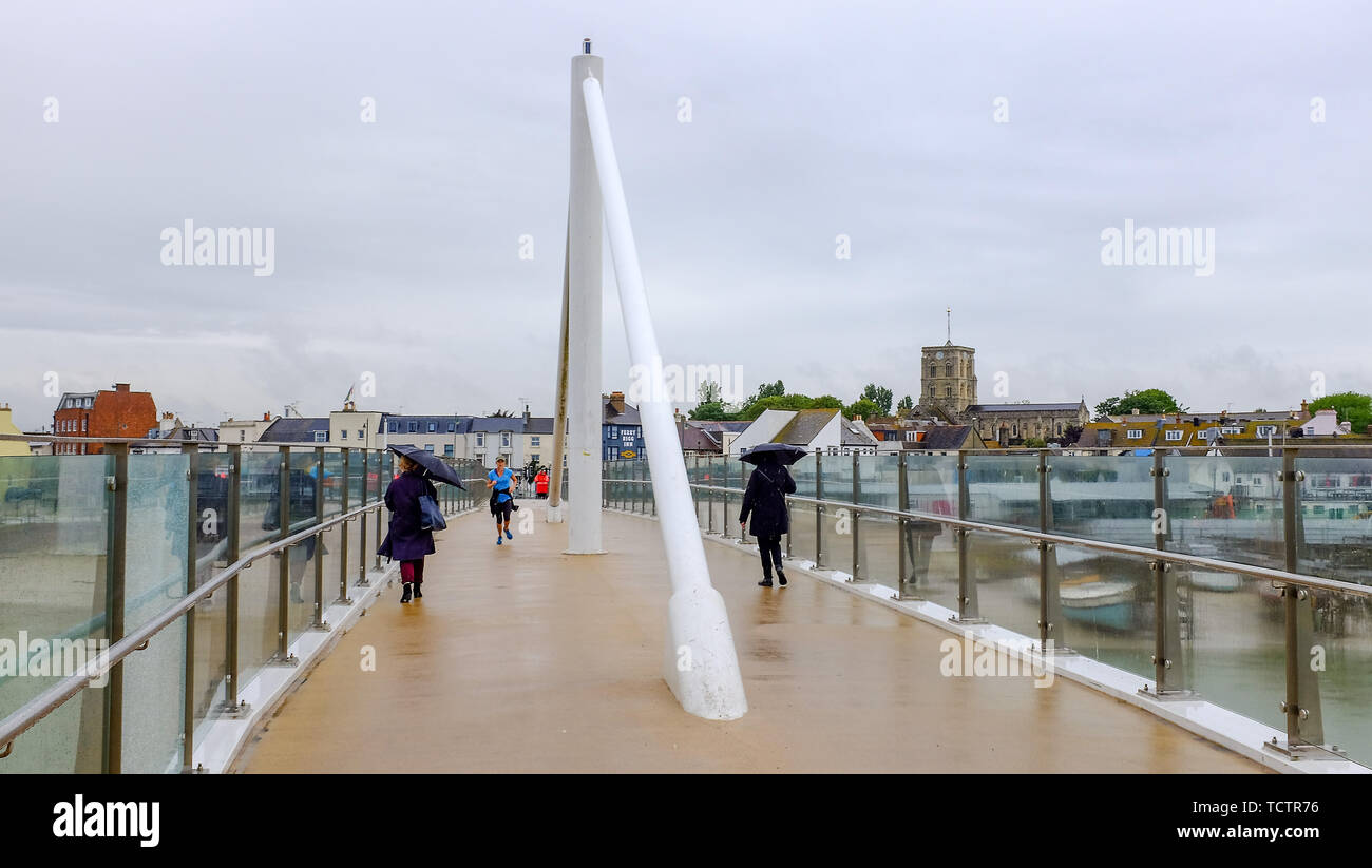 Shorehambysea, Sussex, UK. 10th June 2019. Umbrellas are out as