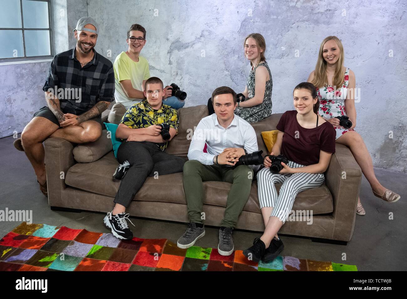 07 June 2019, Bavaria, Munich: Benjamin Jaworskyj (above l-r), photographer, author and web video producer, Levin Sackhoff, sofa Mila Kapaun, Anna-Lena Kockmann, Benjamin Tielmann (below l-r), Anton Engelhardt and Leoni Kipka, participants of the ZDF programme 'Die Kamerahelden - Deine Schule, Deine Fotos', sit on the set in the Werk3Studio. The new Factual series is created for ZDF in Munich. In eight episodes, pupils between the ages of 15 and 16 from several schools in Germany will compete against each other in a photo competition to present the diversity of the school environment in German Stock Photo