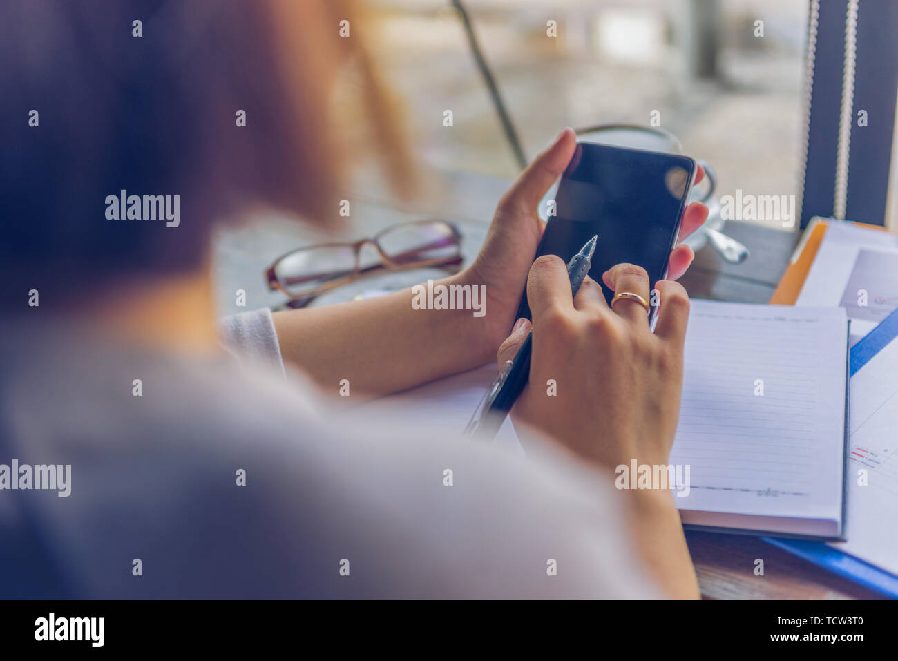 Woman and texting and rear view hi-res stock photography and images - Alamy