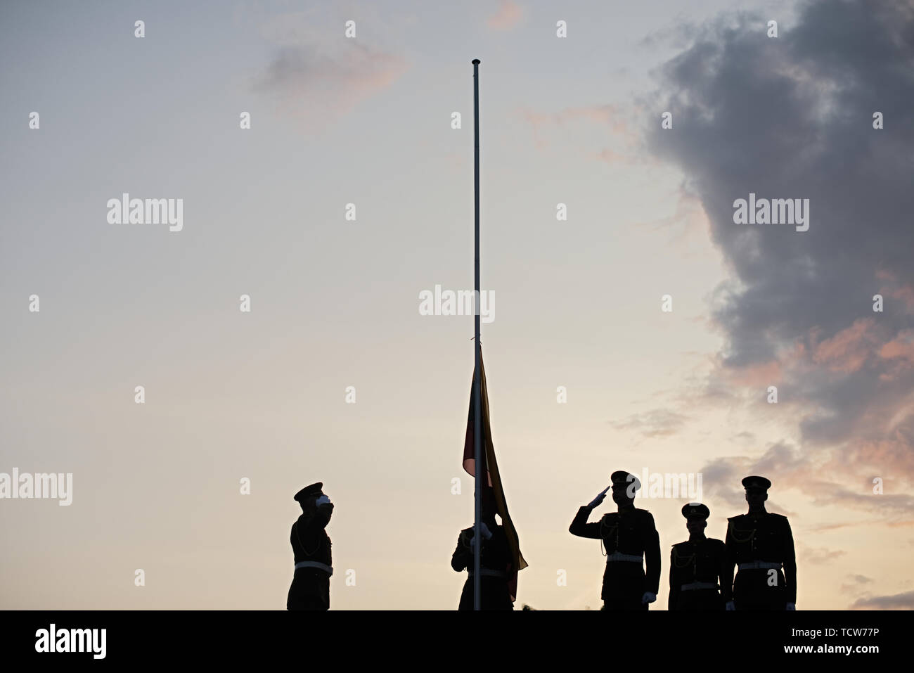 Soldiers Raising The Lithuanian Flag At Sunset Stock Photo