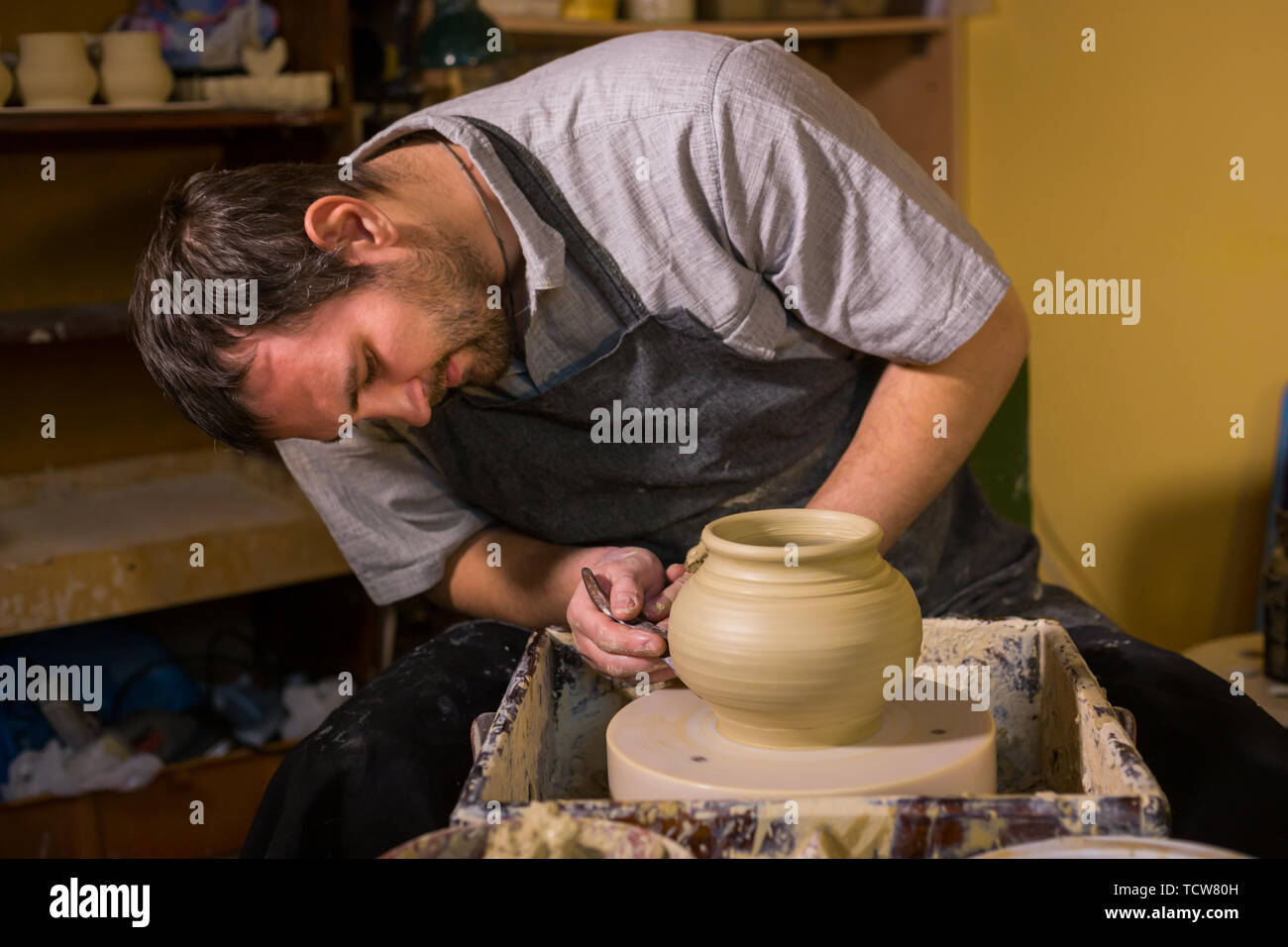 Professional male potter shaping pot Stock Photo - Alamy