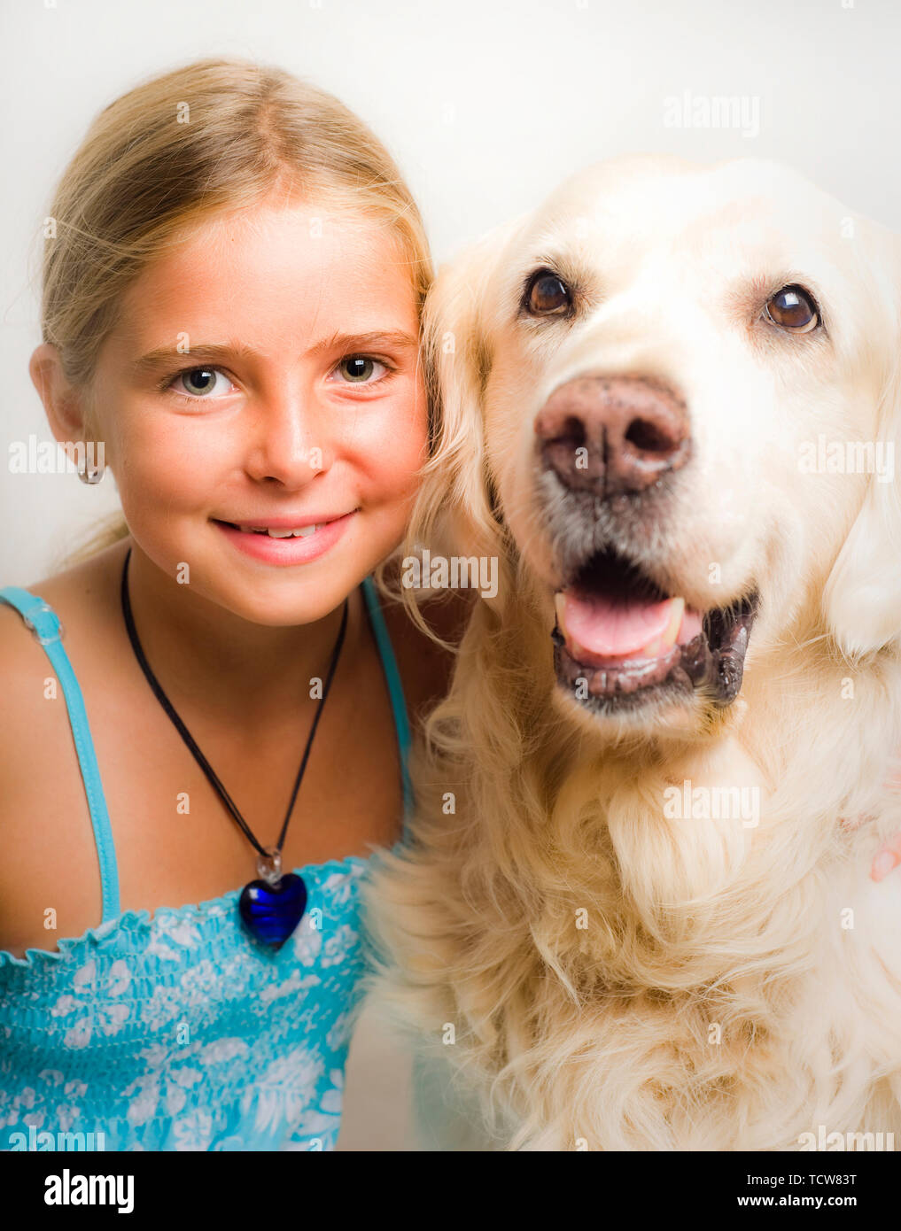 10 years girl with her Golden Retriever dog Stock Photo