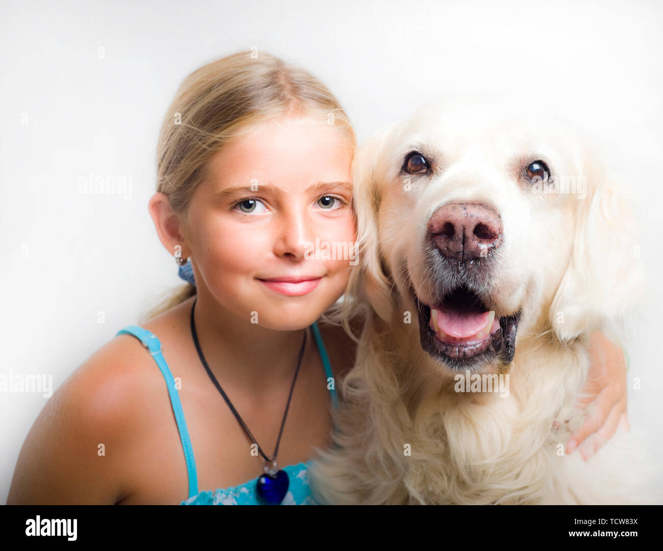 10 years girl with her Golden Retriever dog Stock Photo