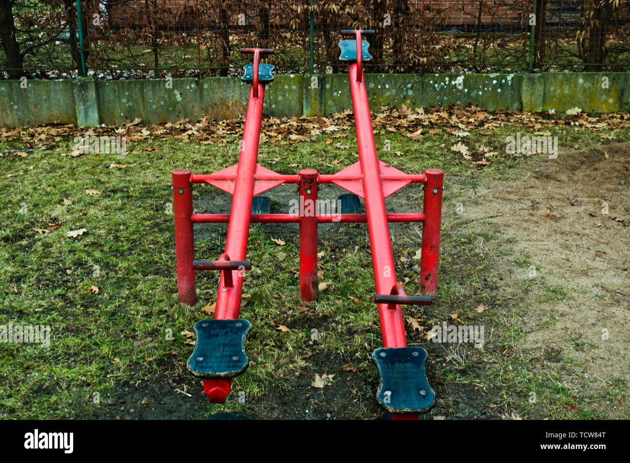 double or twin red seesaw in a playground Stock Photo