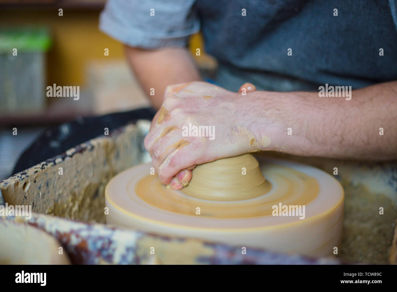 Professional male potter working with clay on potter's wheel Stock ...