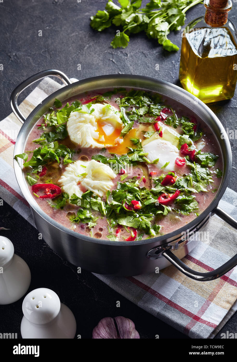 hot mexican spicy red kidney Bean Soup with poached eggs and cilantro