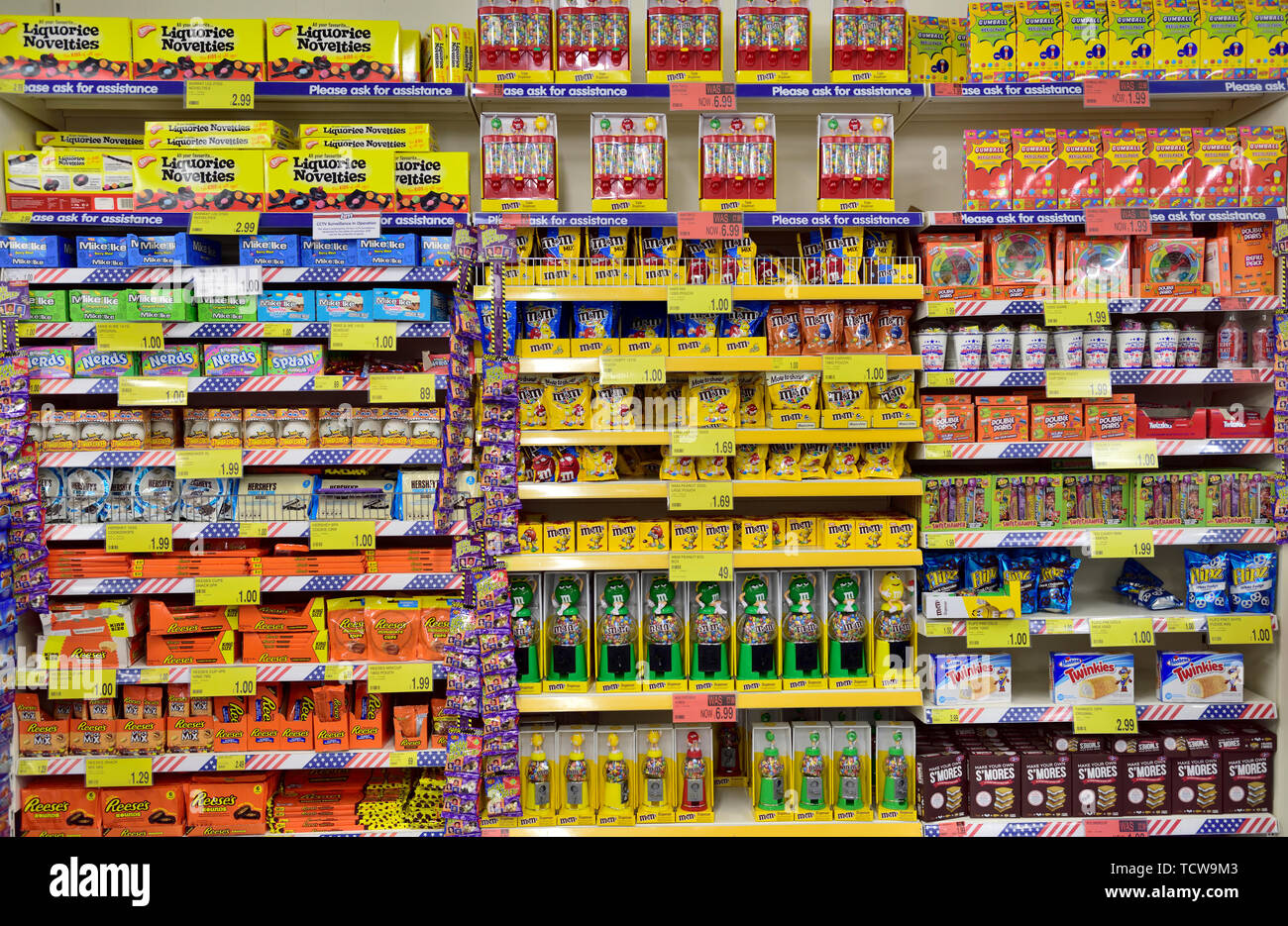 Multiple shelves full of a variety of sweets on display in store. B&M discount store, Bristol Stock Photo