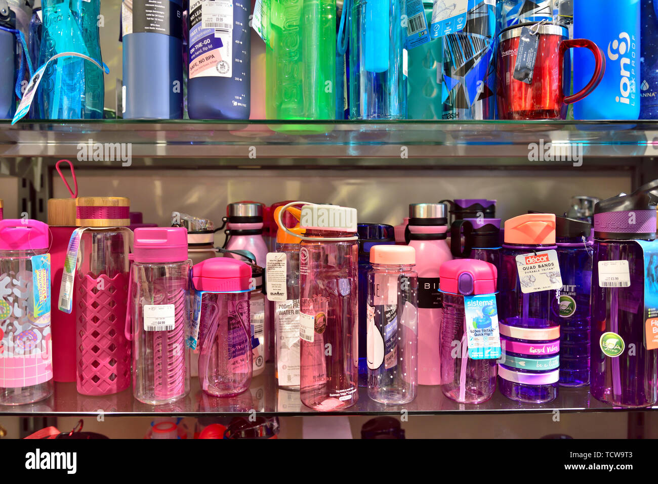 Display of refillable environmentally friendly drinking water bottles on shelves for sale in shop Stock Photo