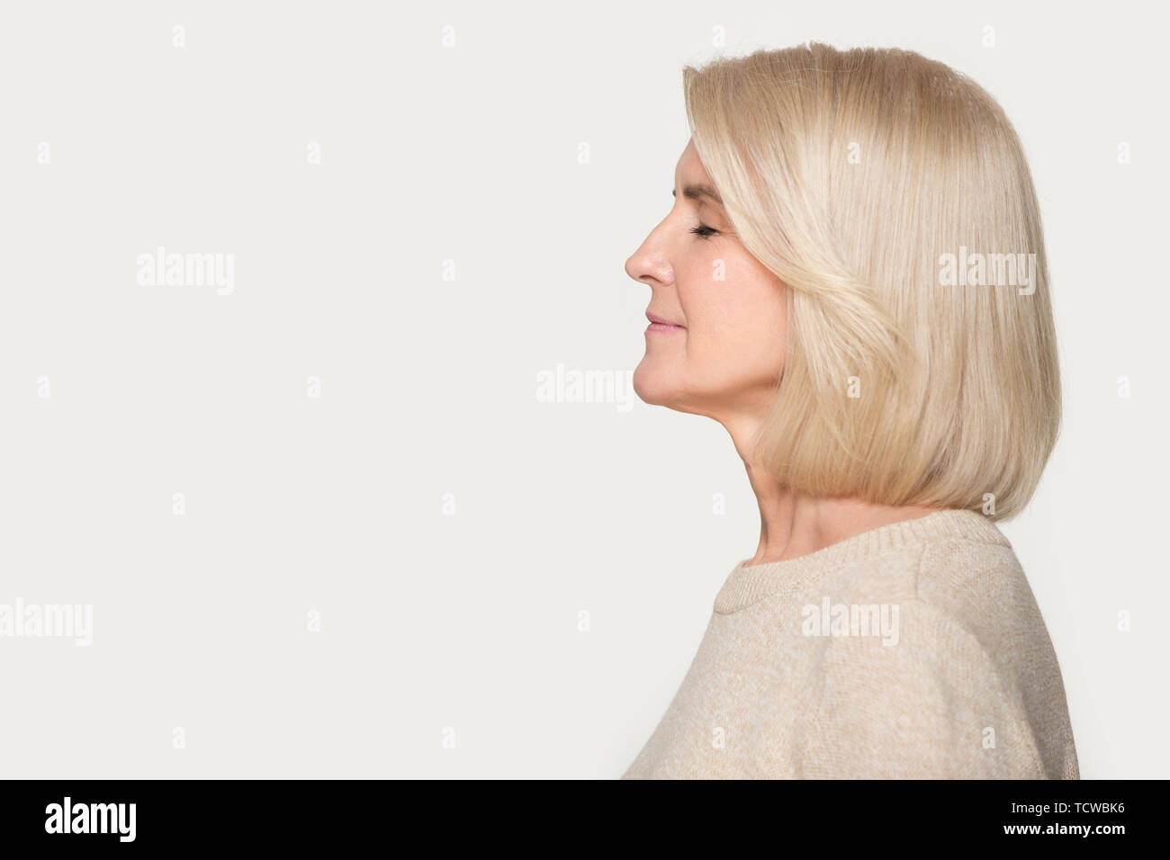 Old woman side profile white background hi-res stock photography and