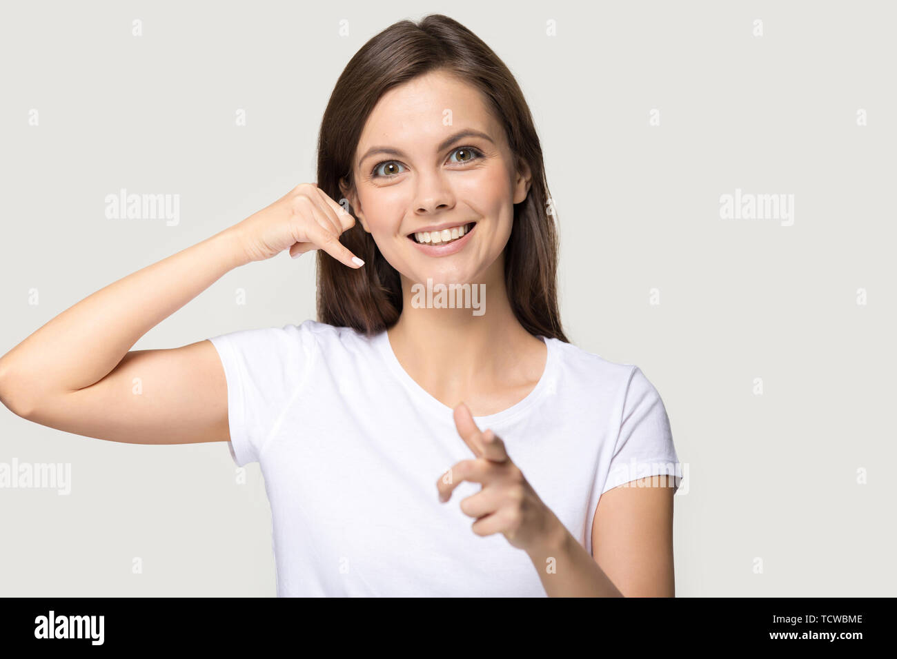 Woman imitate cellphone with hand make call me gesture Stock Photo