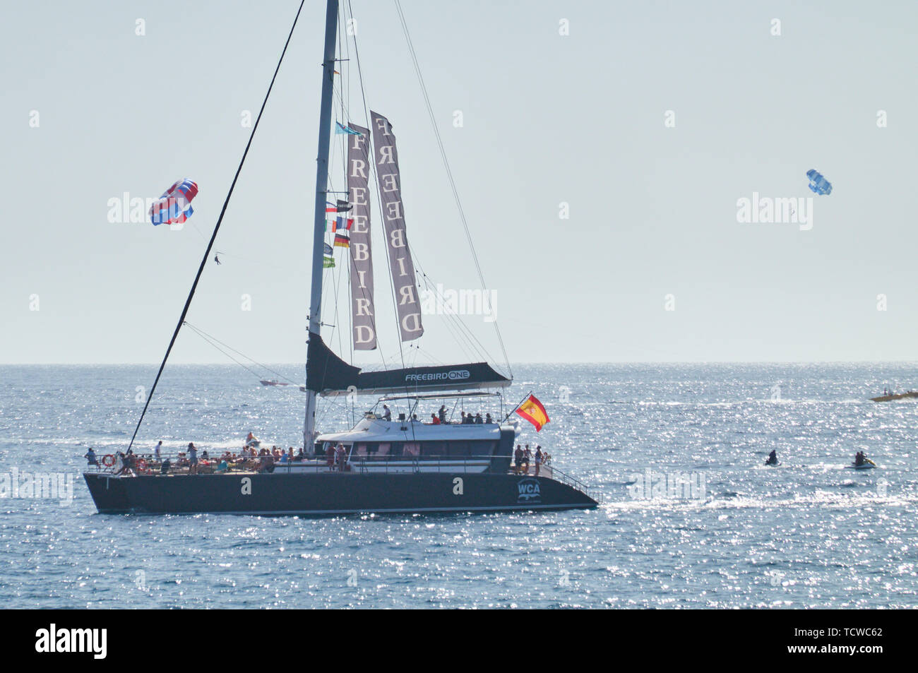 Sailing boat with tourists sunbathing in Adeje, Tenerife, Spain, March