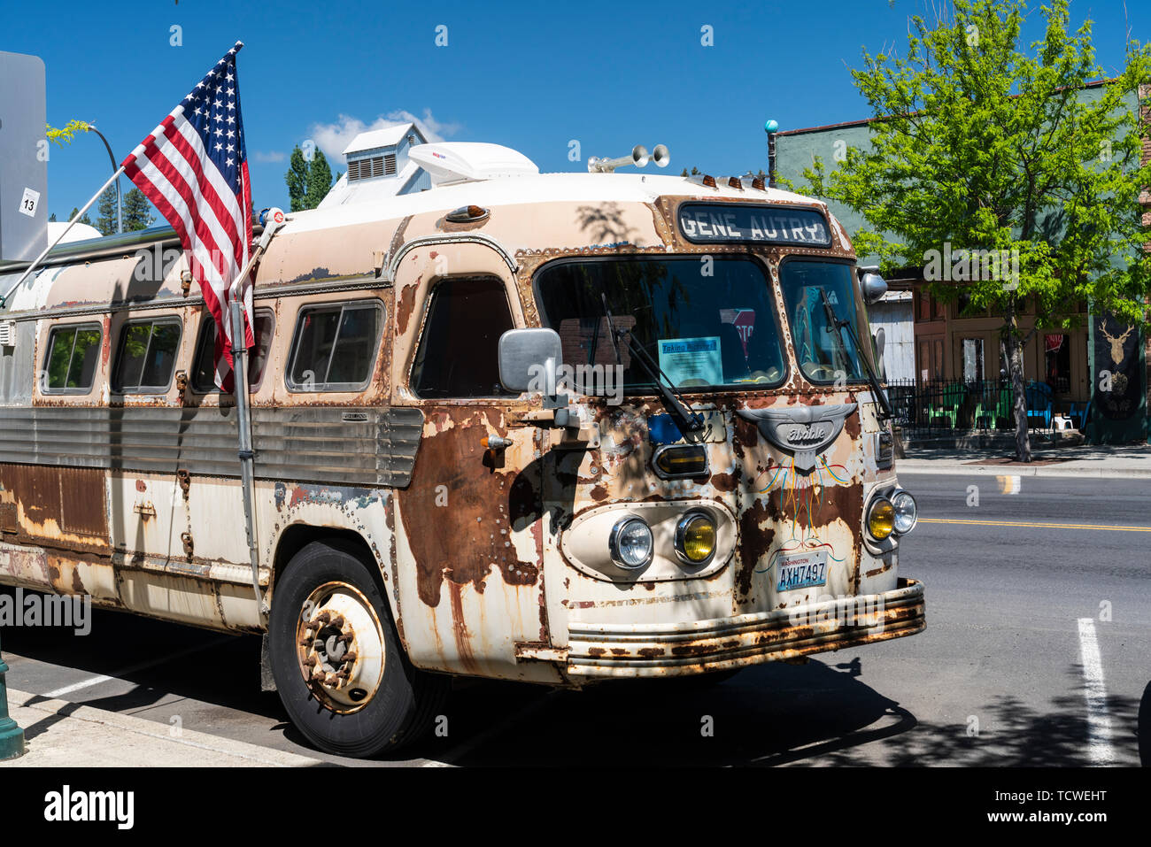 An old bus and American flag on the street in the village of Palouse