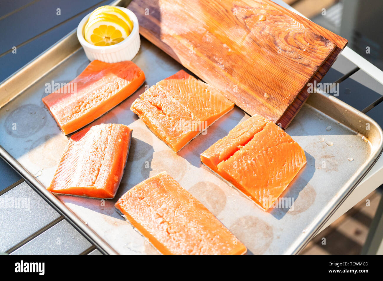 Grilling salmon on a gas burning grill on the backyard patio Stock