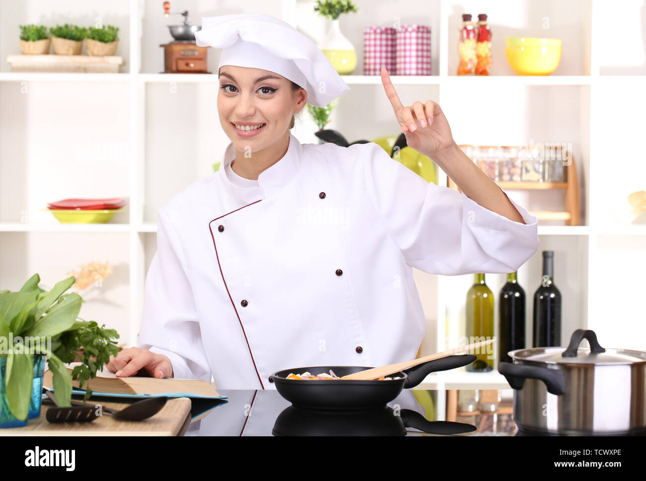 Young Woman Chef Cooking In Kitchen Stock Photo Alamy