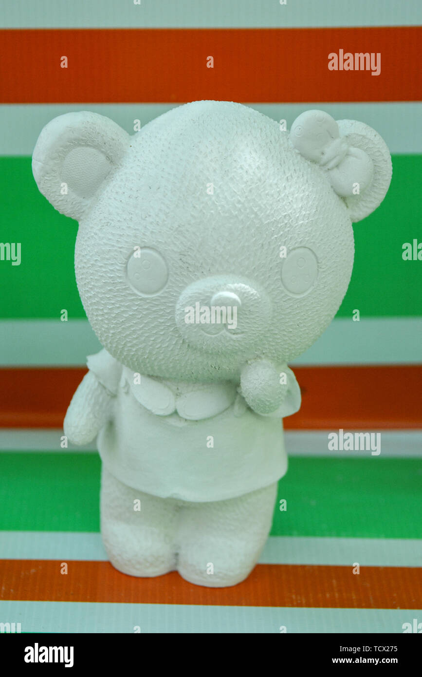 Young bear toy on the stripes background. Stock Photo
