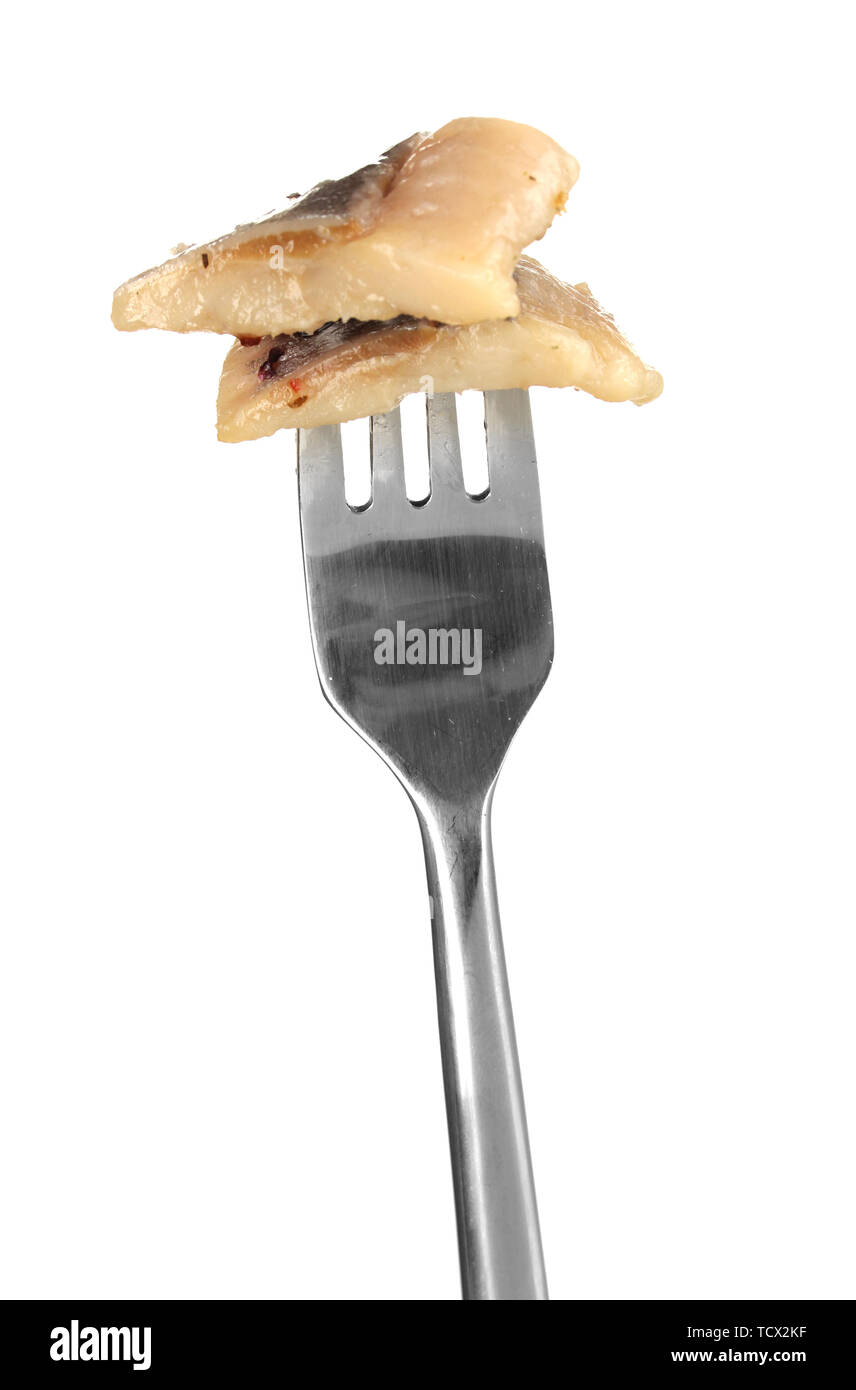 Pieces of herring on fork isolated on white Stock Photo - Alamy