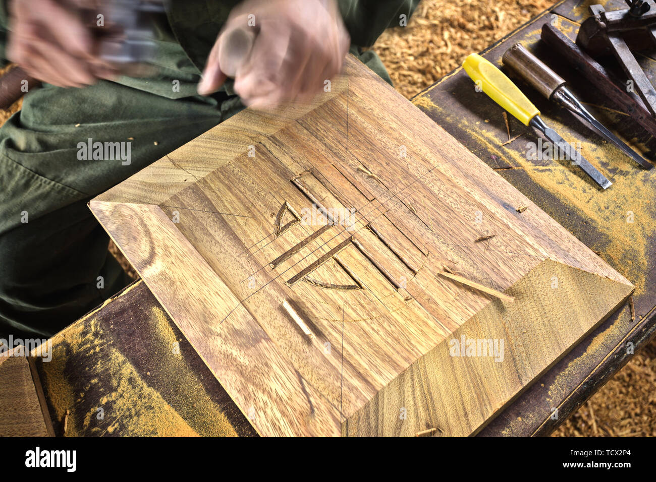 wood chisel carpenter tool hammer in hand working wooden background ...