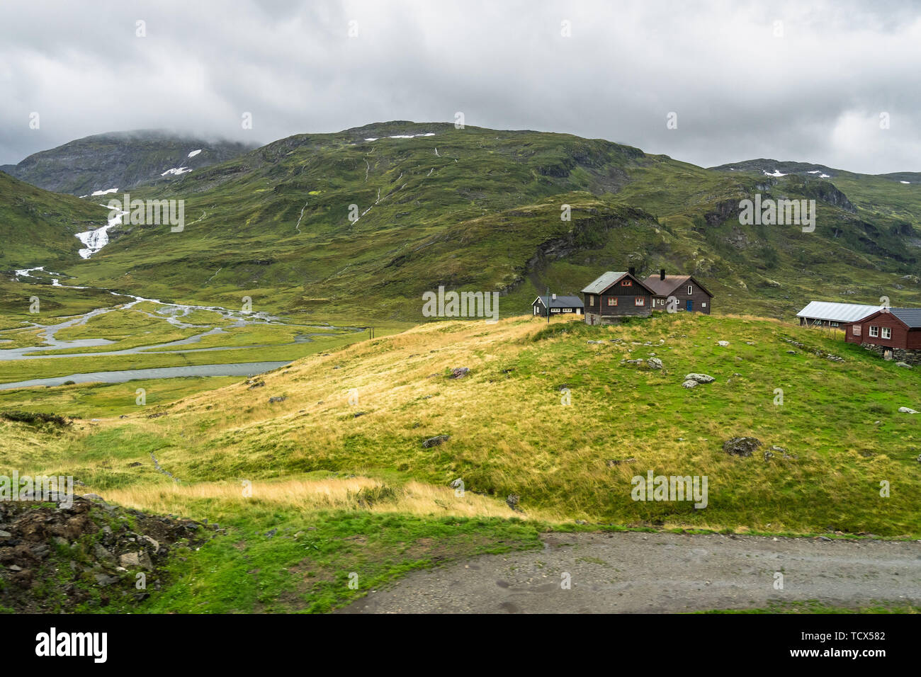 Landscape with isolated house on the plateau of Hardangervidda National Park in Norway. Photo taken from Oslo-Bergen train Stock Photo