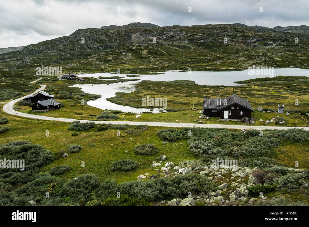 A remote village surrounded by mountains and lakes on the plateau of Hardangervidda National Park, Norway. Photo taken from Oslo-Bergen train Stock Photo