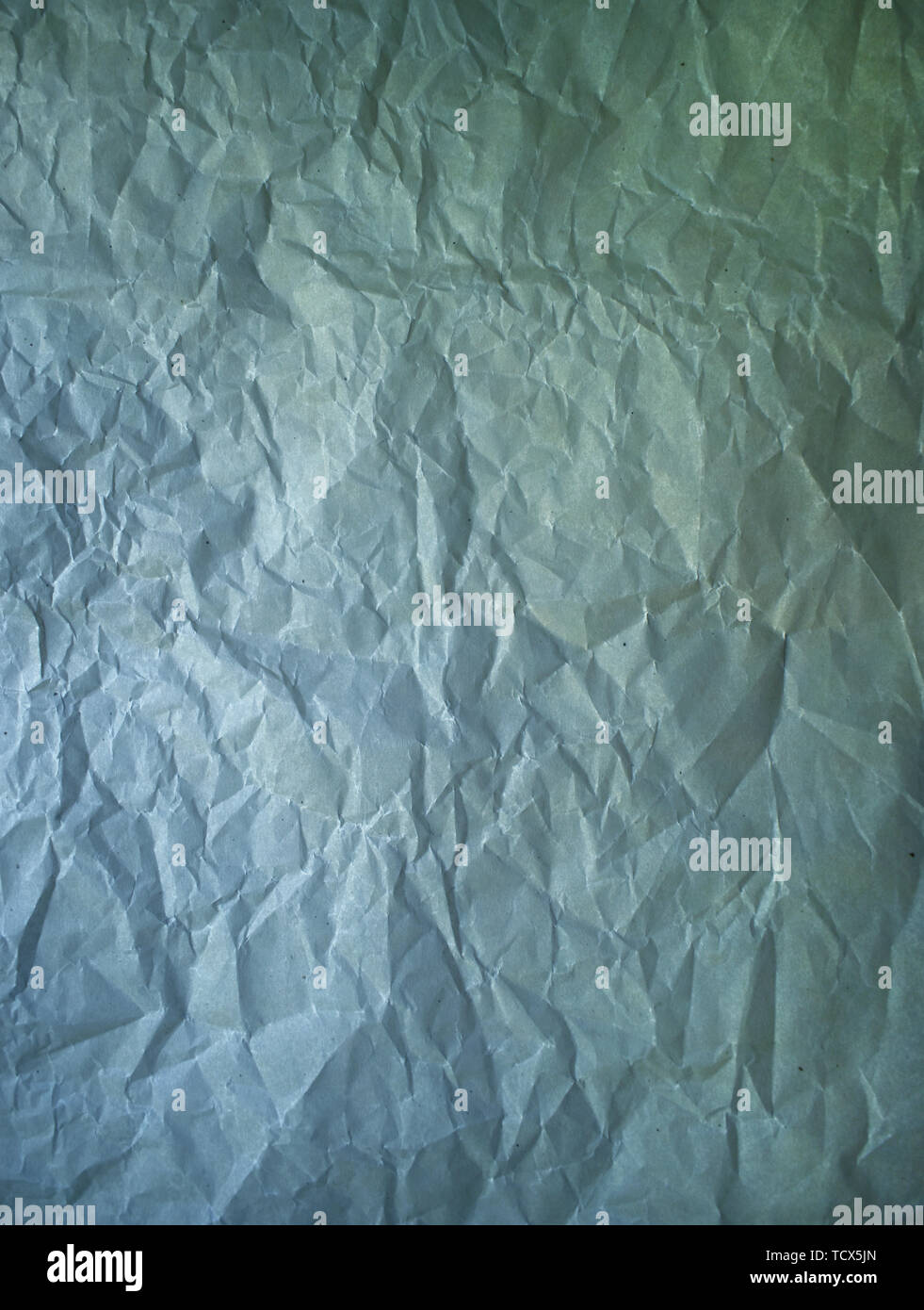 Old crumpled paper vintage texture. Rough wrinkled dark green blue color shadows sheet. Textured grunge background with copy space Stock Photo