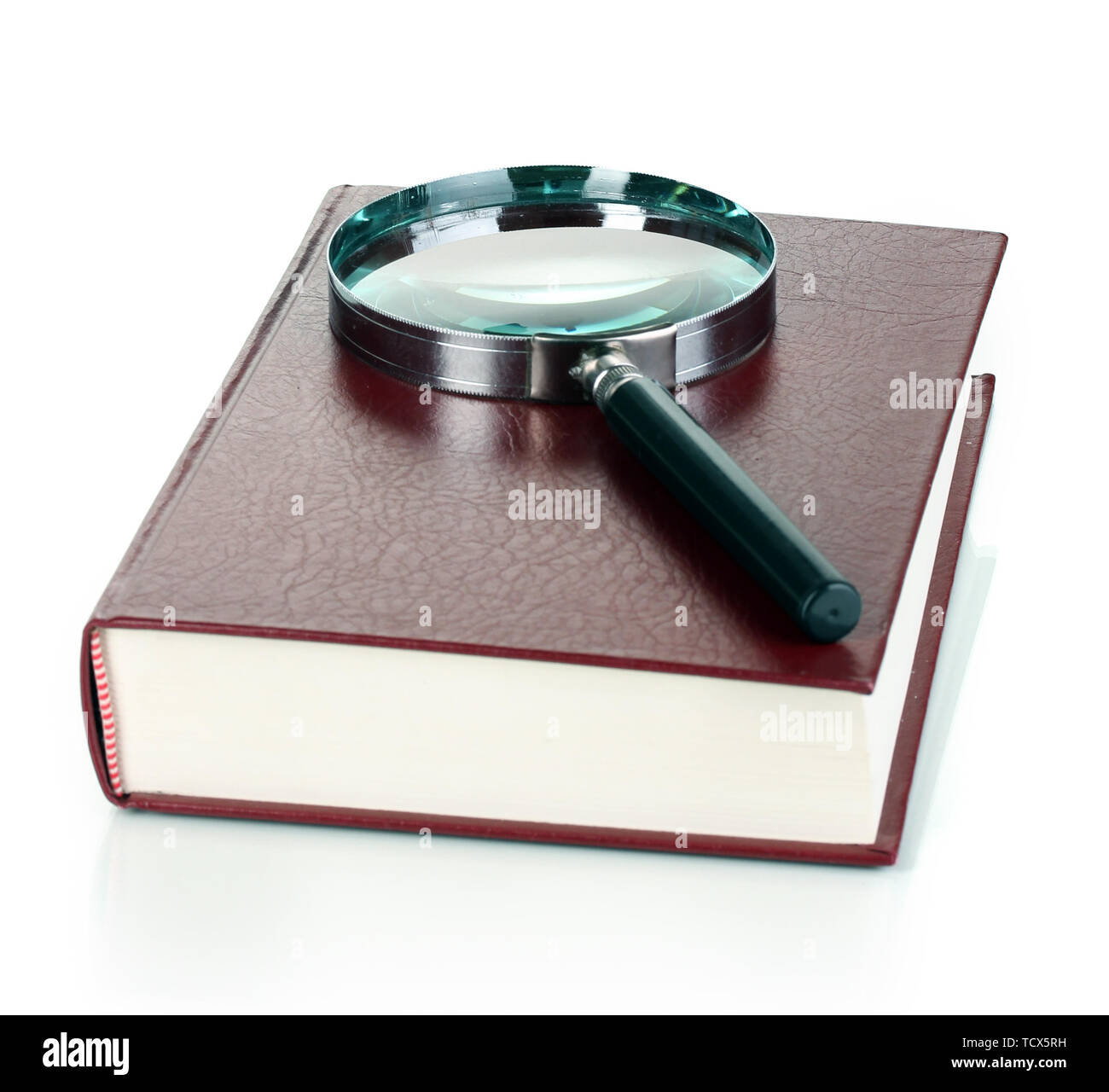 Magnifying glass and book isolated on white Stock Photo - Alamy