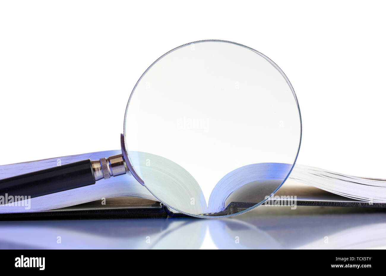 Magnifying glass and open book isolated on white Stock Photo - Alamy