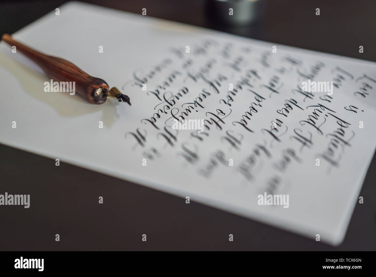 Calligrapher hands writes phrase on white paper. Bible phrase about ...