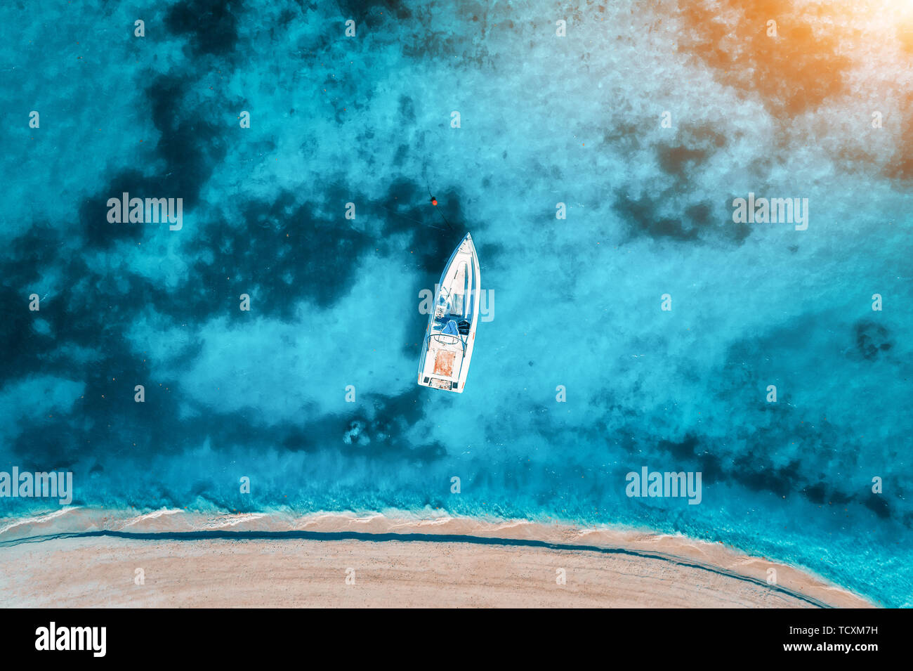 Aerial view of the white yacht in the clear blue water at sunset Stock ...