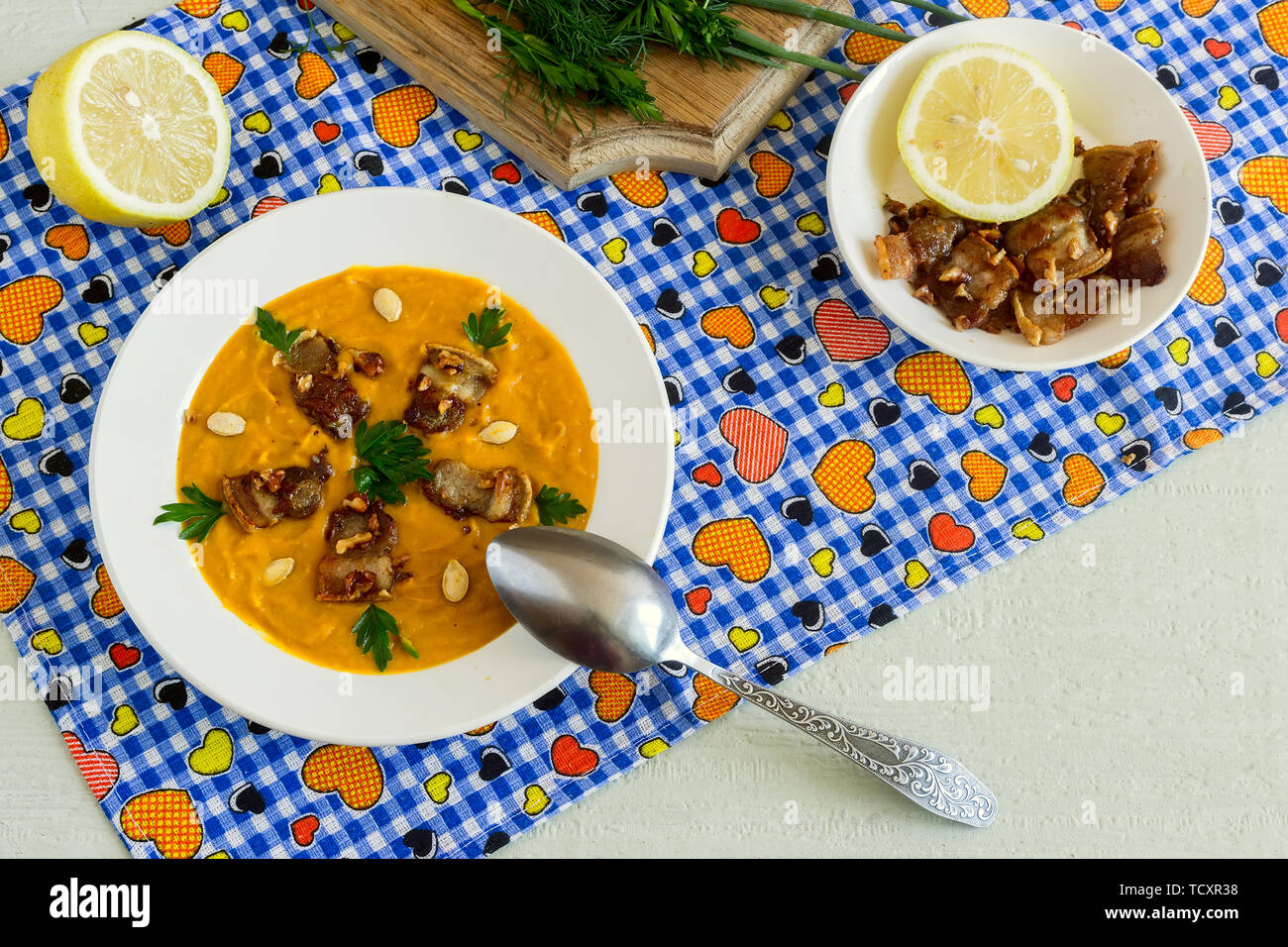 Pumpkin soup with bacon fried with nuts. Stock Photo