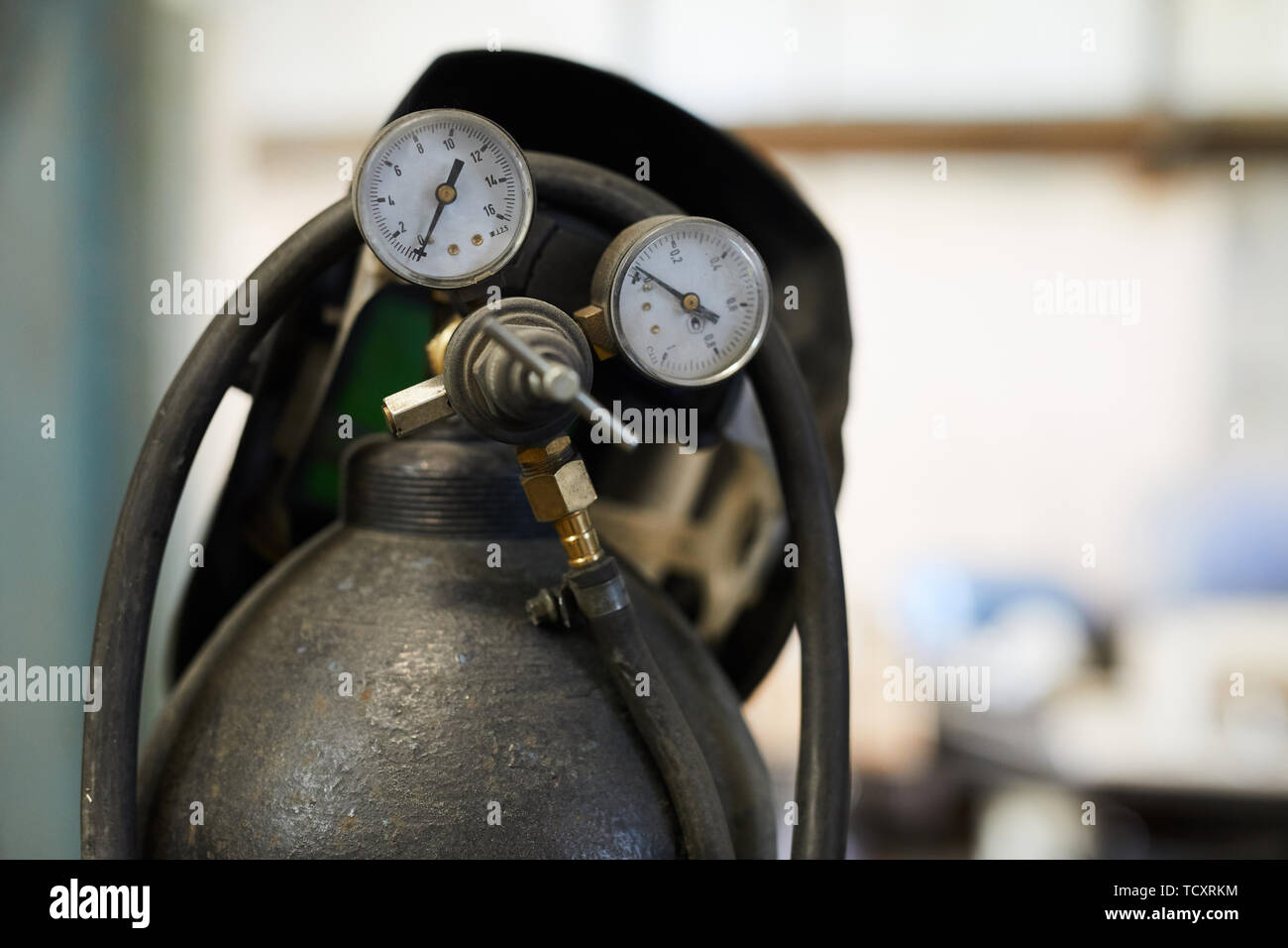 Closeup of air tank cylinder with tubes and pressure gauges, welding
