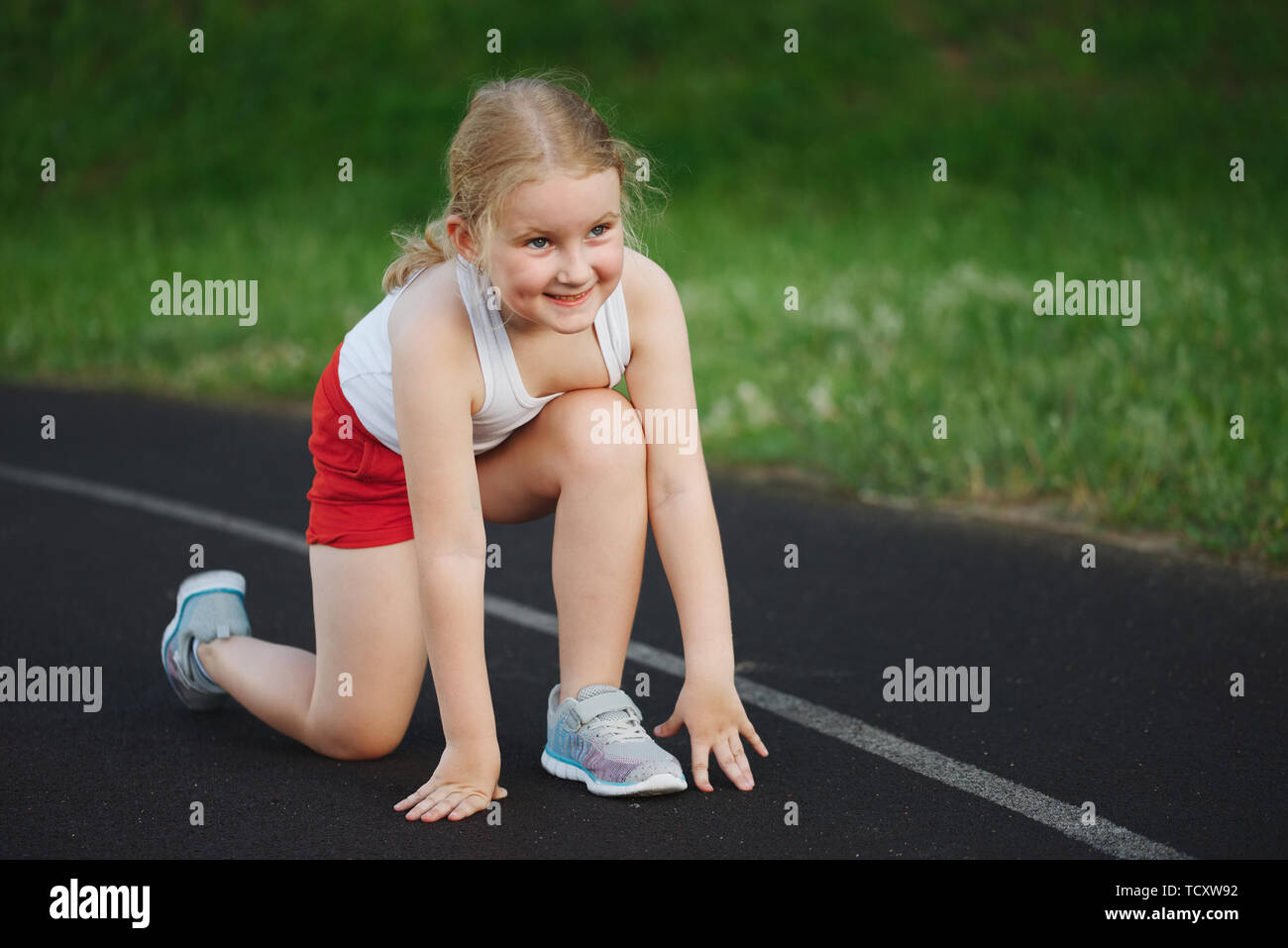 little happy girl running on the stadium Stock Photo Alamy