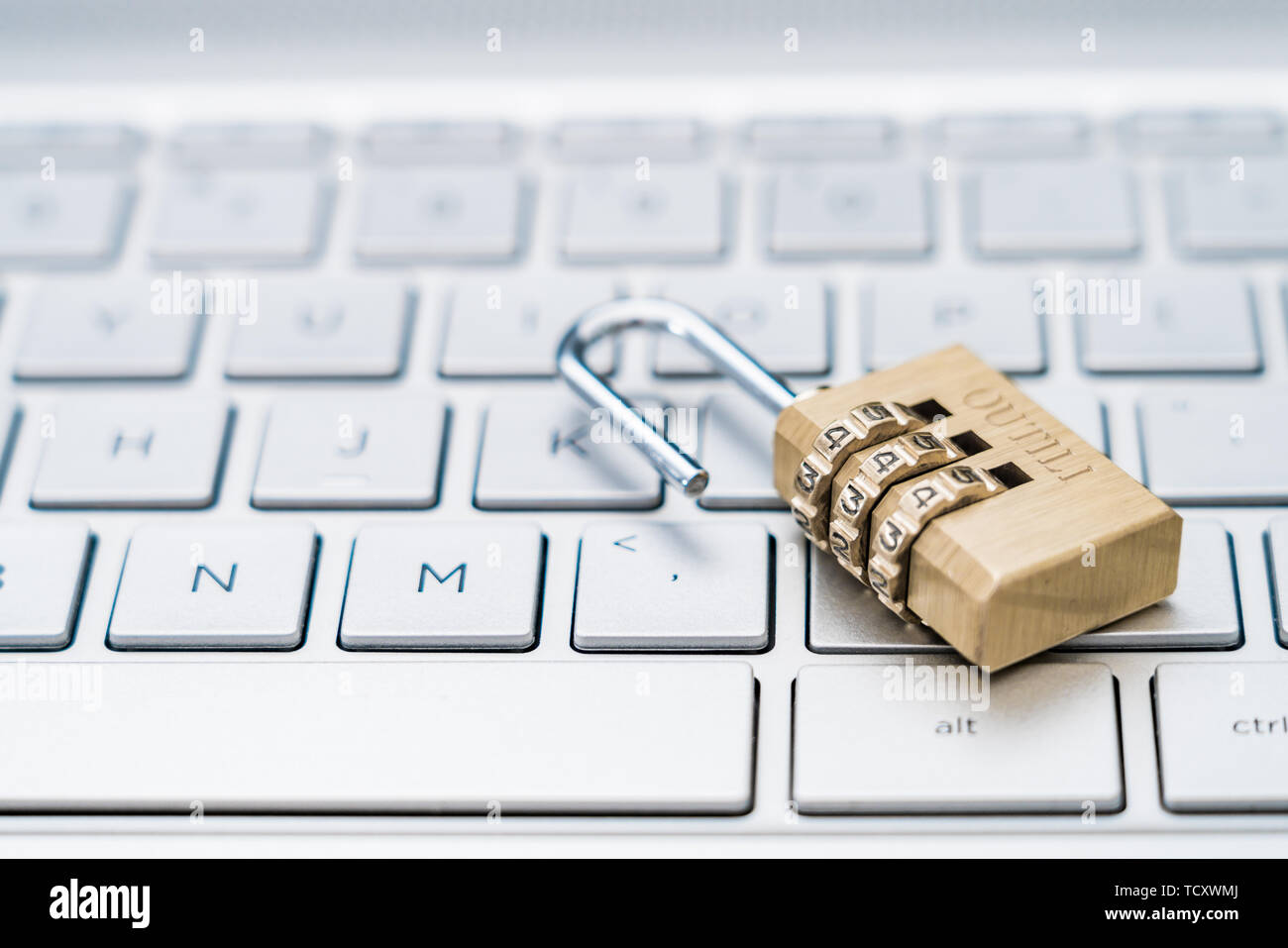 An open lock on a computer keyboard. Stock Photo