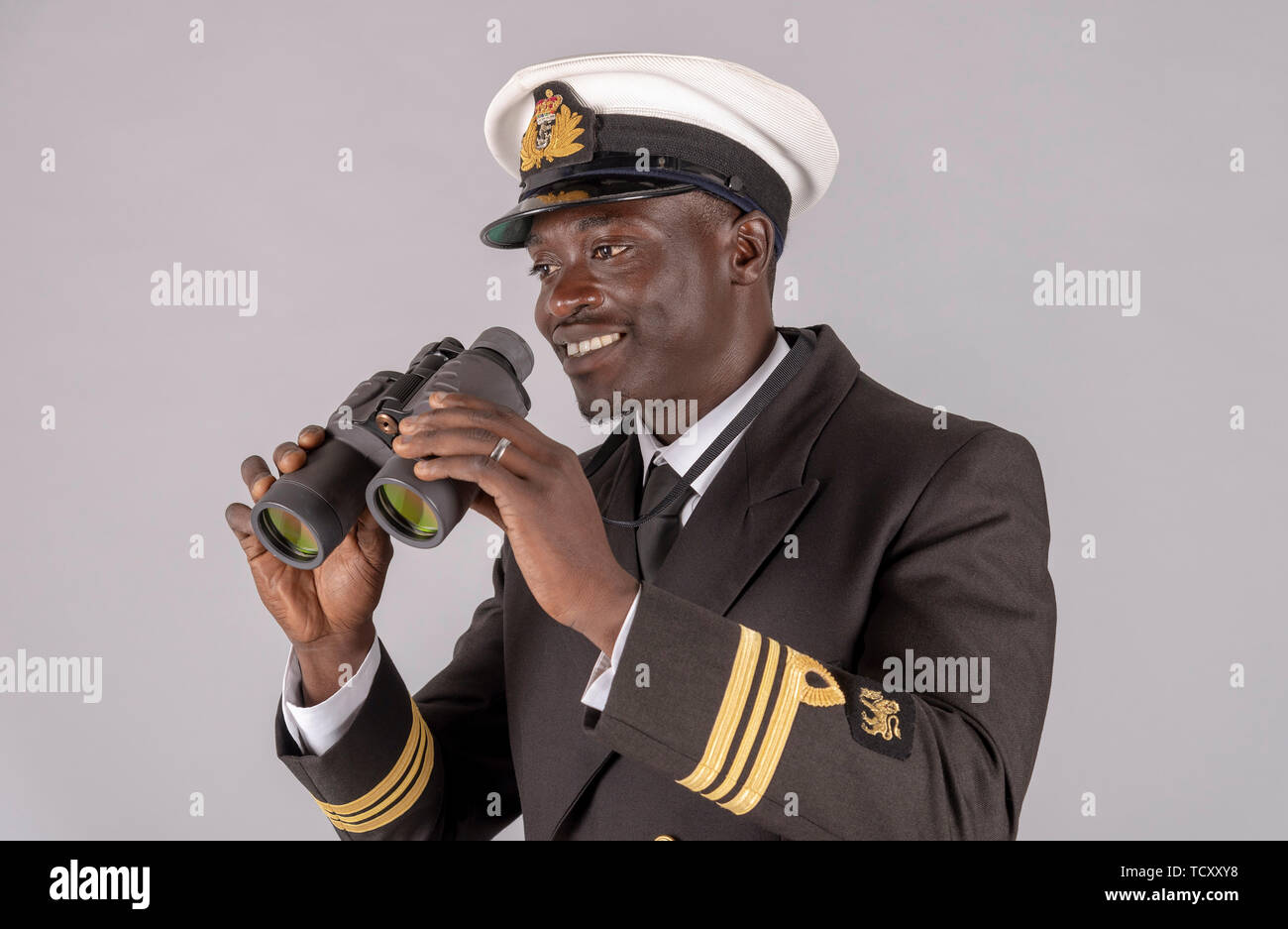 England, UK. May 2019. A naval officer in uniform holding a pair of binoculars Stock Photo