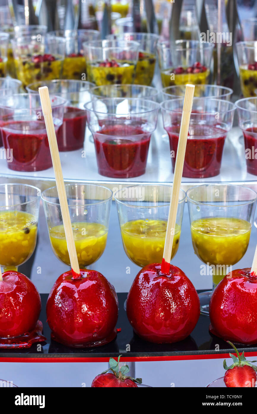 Red caramel apples on the wooden sticks Stock Photo