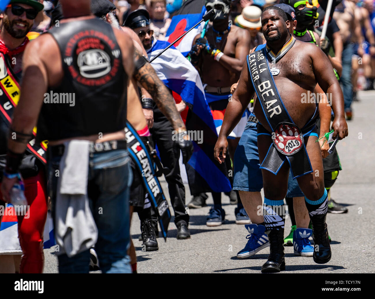 A man wears a sash that says Mr. LA Leather Bear during the LA Pride Parade in West Hollywood, California. The 49th annual gay pride parade includes a music festival and a parade that draws large crowds. Stock Photo