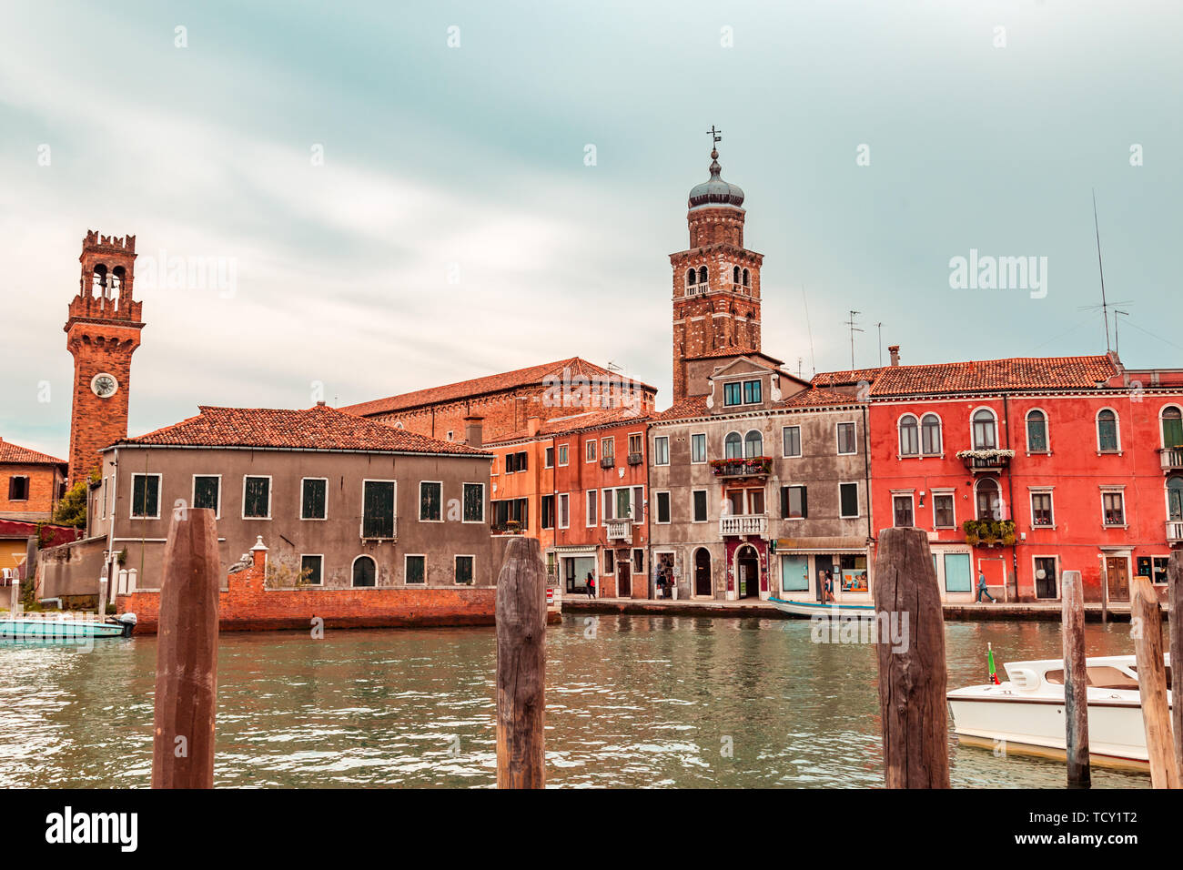 Venice Italy - May 25, 2019: View on Murano island with the central canal, bridge, boats, shops and tourists during sunset Stock Photo